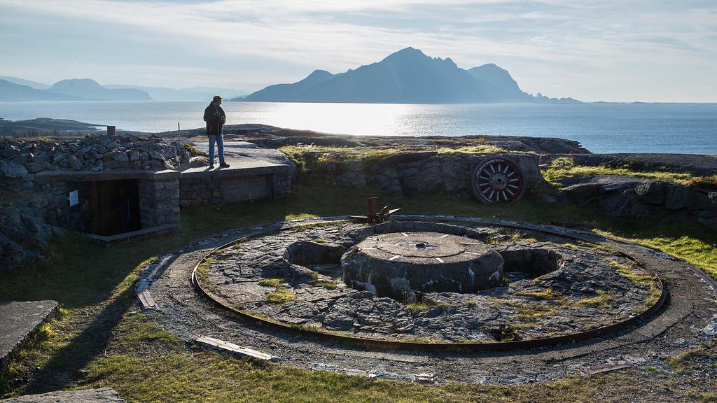 A man looking at parts of a fort.