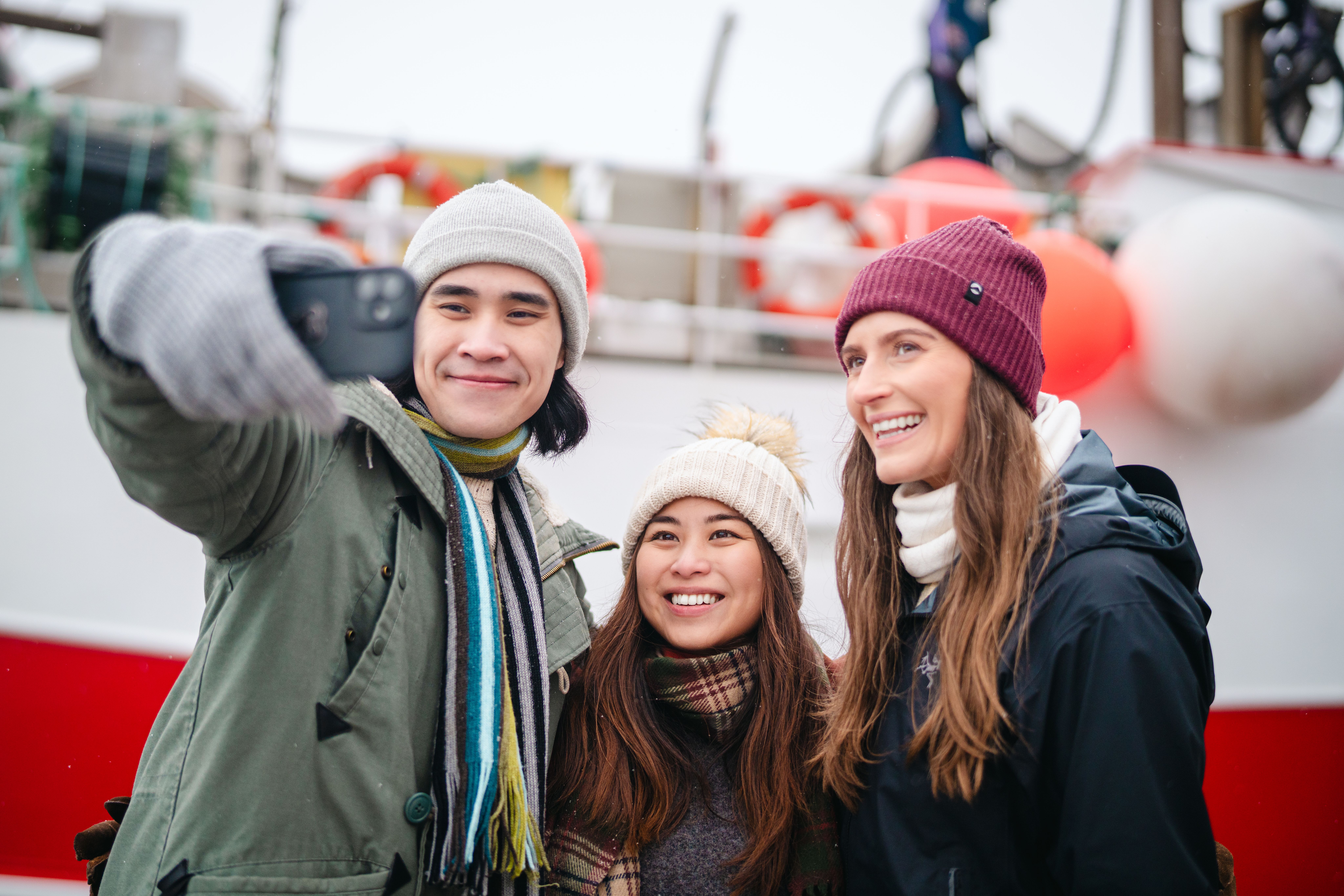 Two tourists taking a selfie with a local.