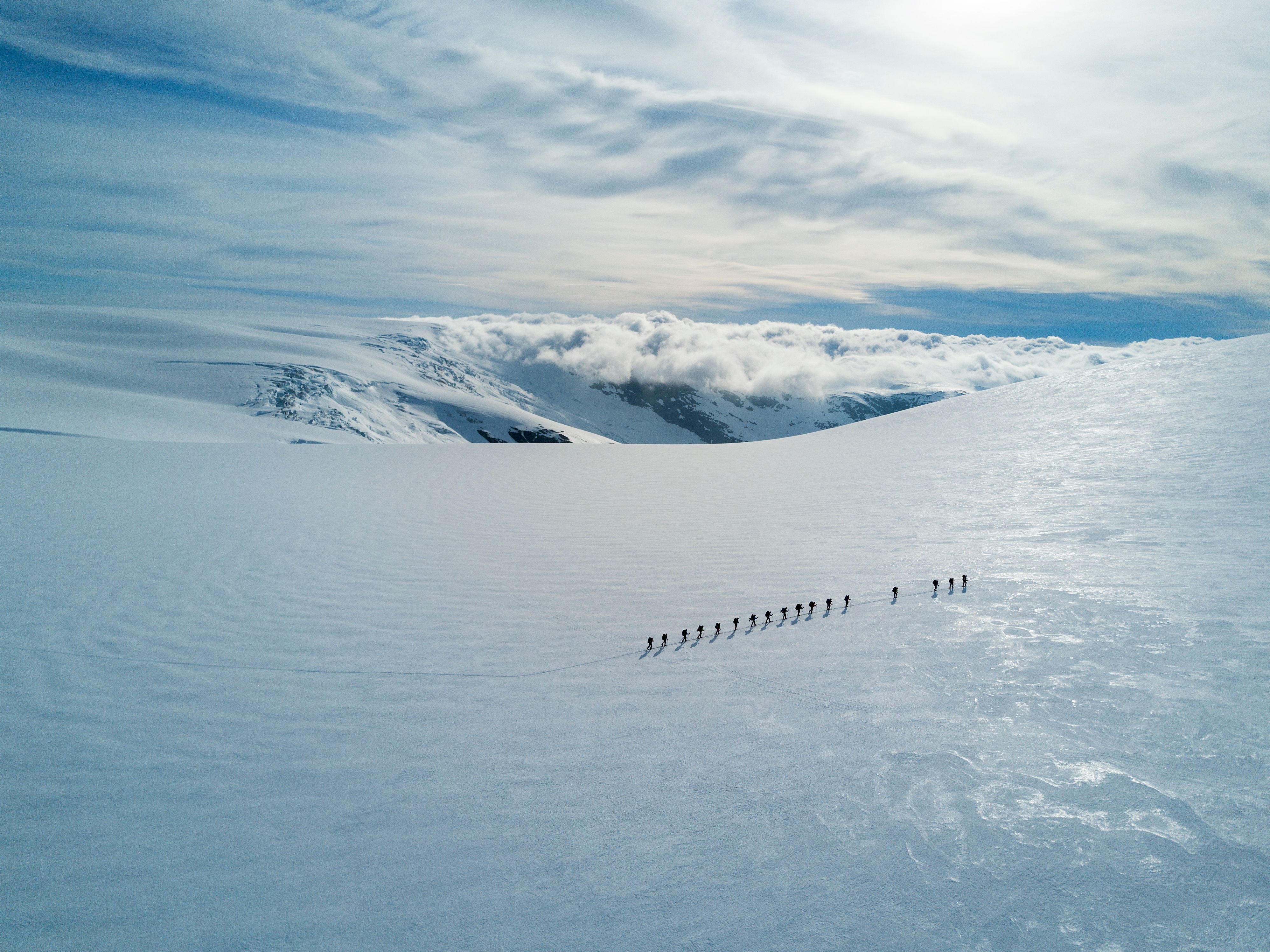 People crossing a glacier.
