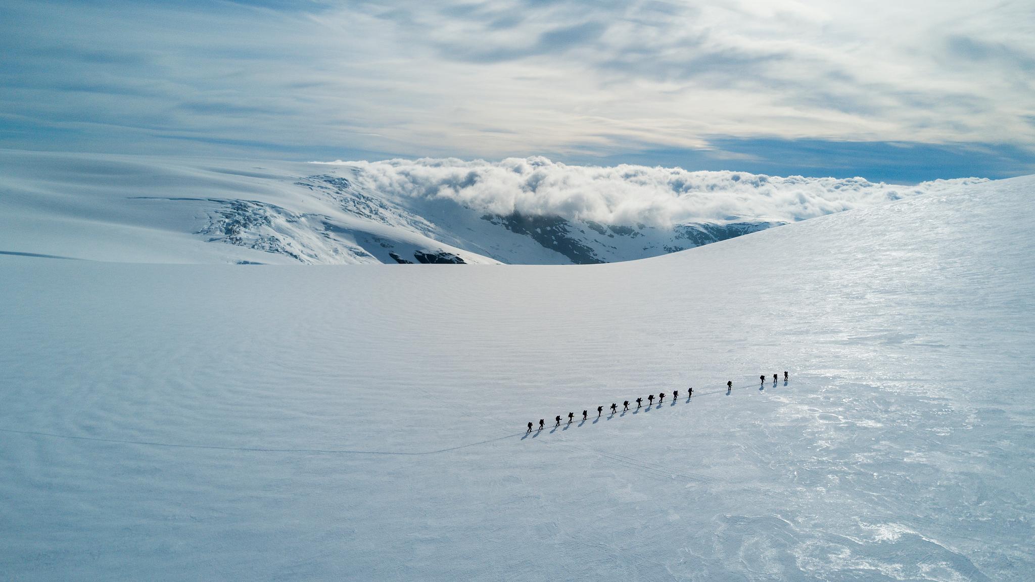 People crossing a glacier.