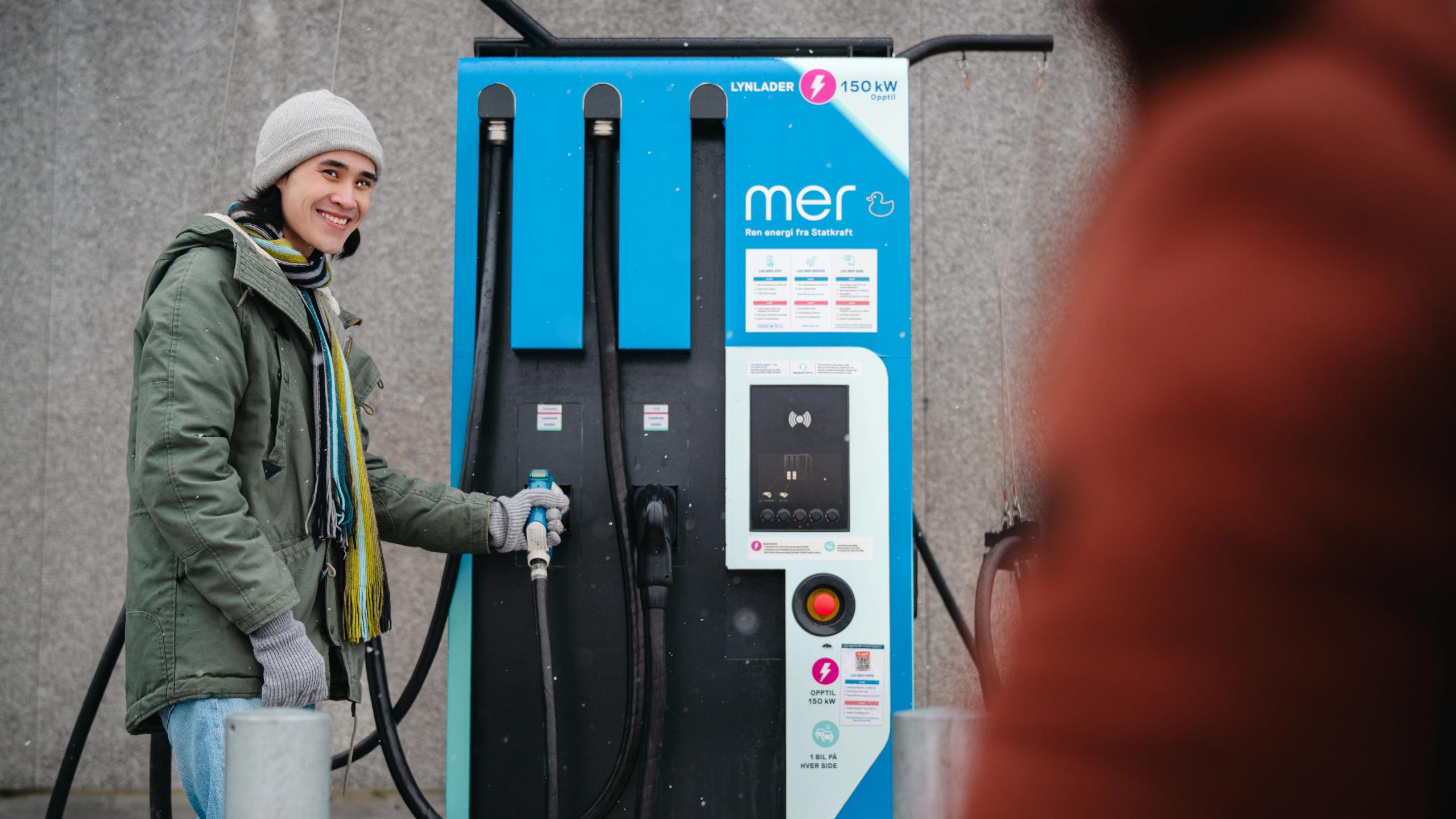 A man charging a car.
