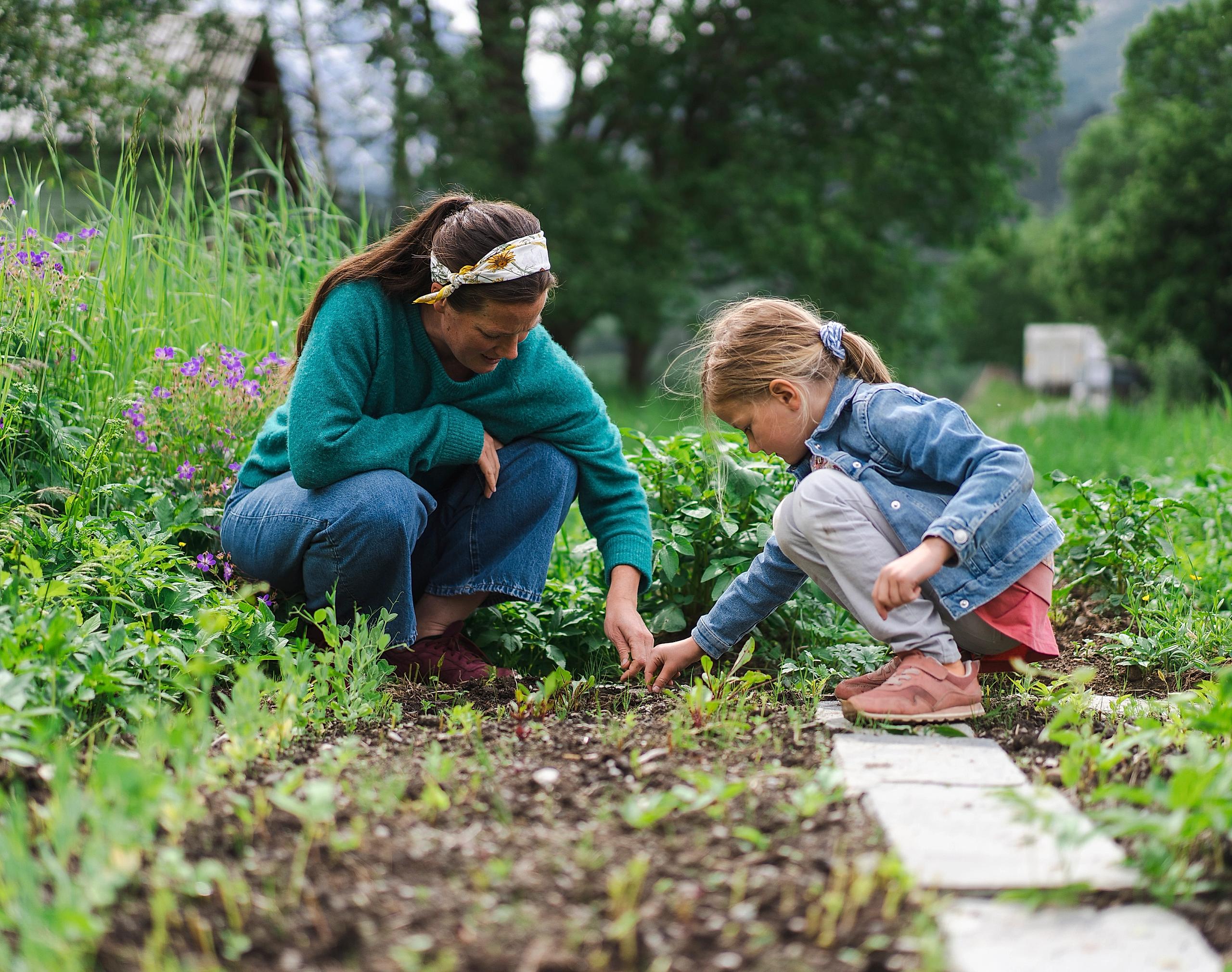 A woman and a girl are gardening at Romsdal Lodge.