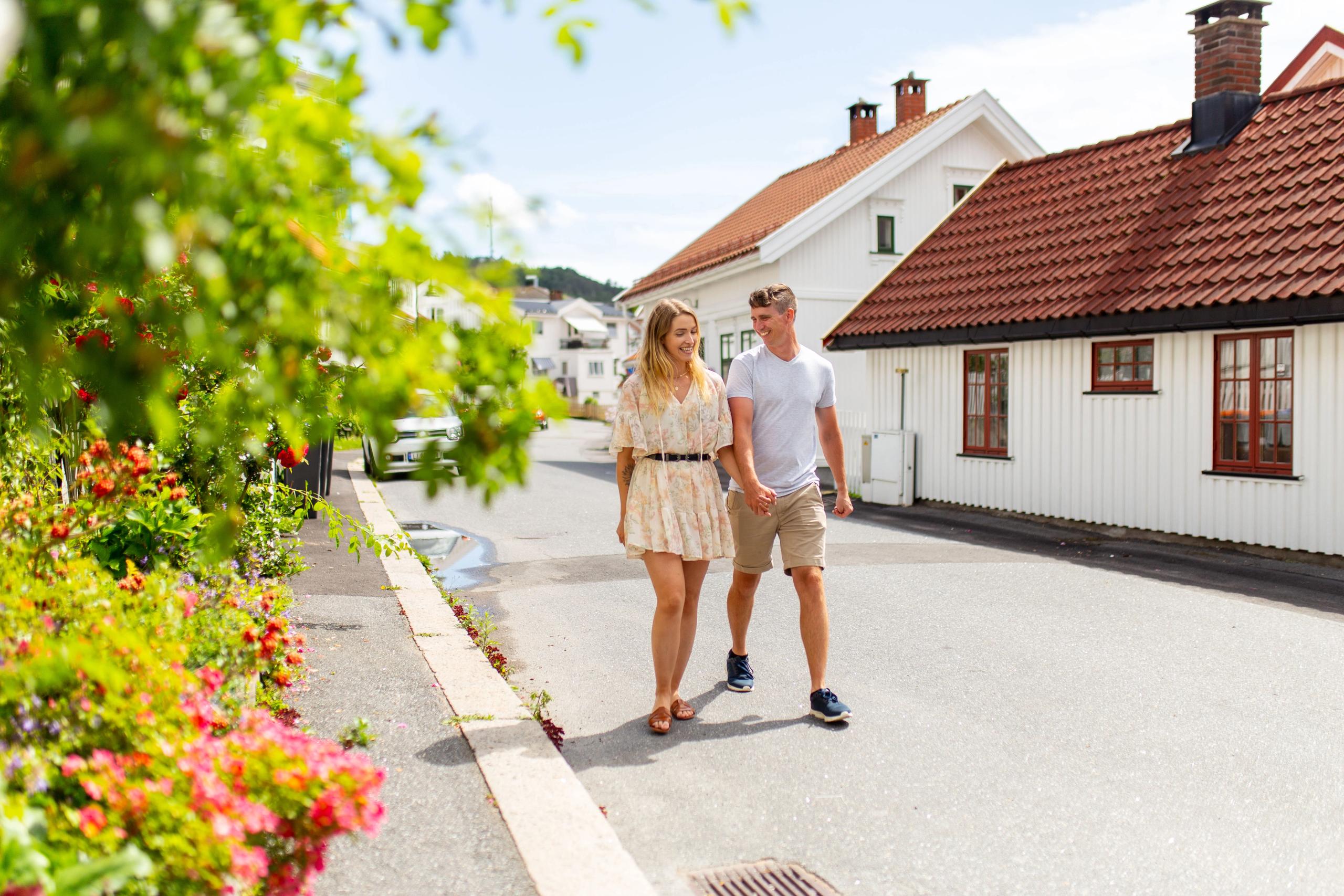 A woman and a man is walking in a cozy street in Sandefjord in Eastern Norway
