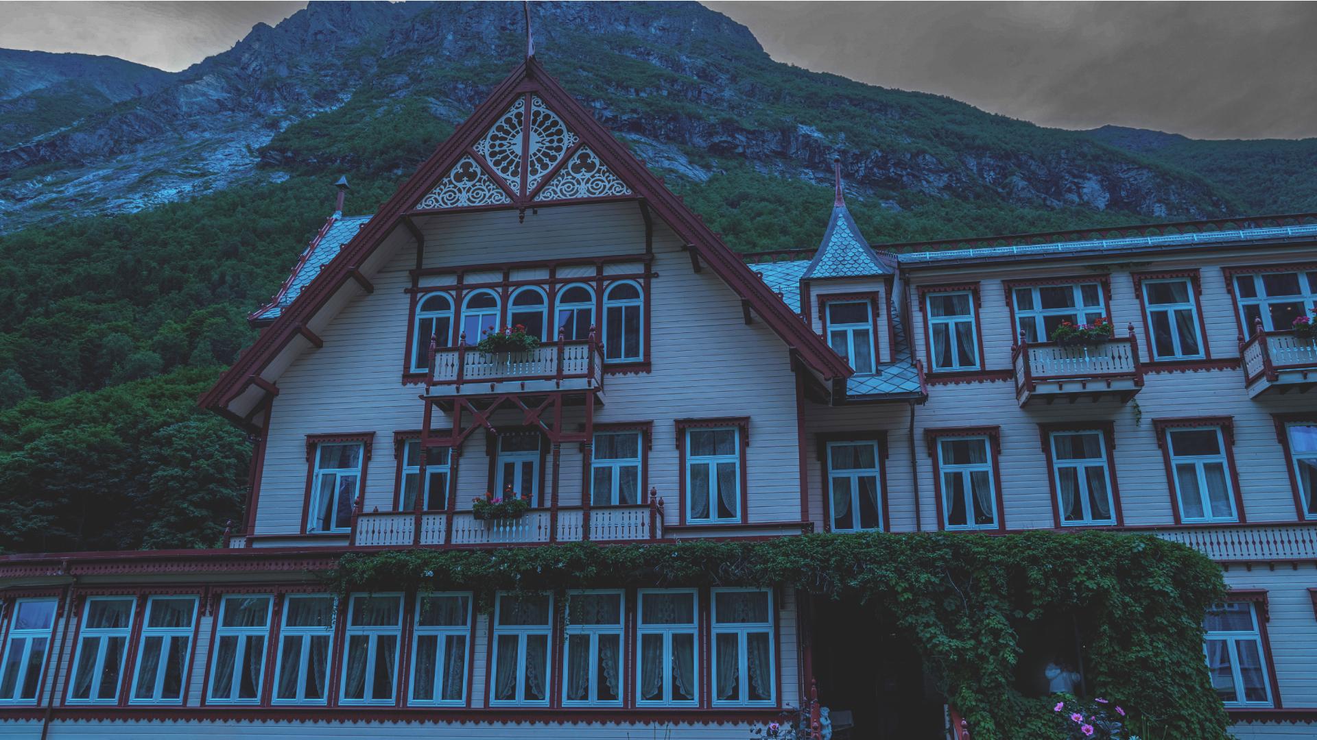 Hotel Union Øye seen from the front with a spooky light in Fjord Norway