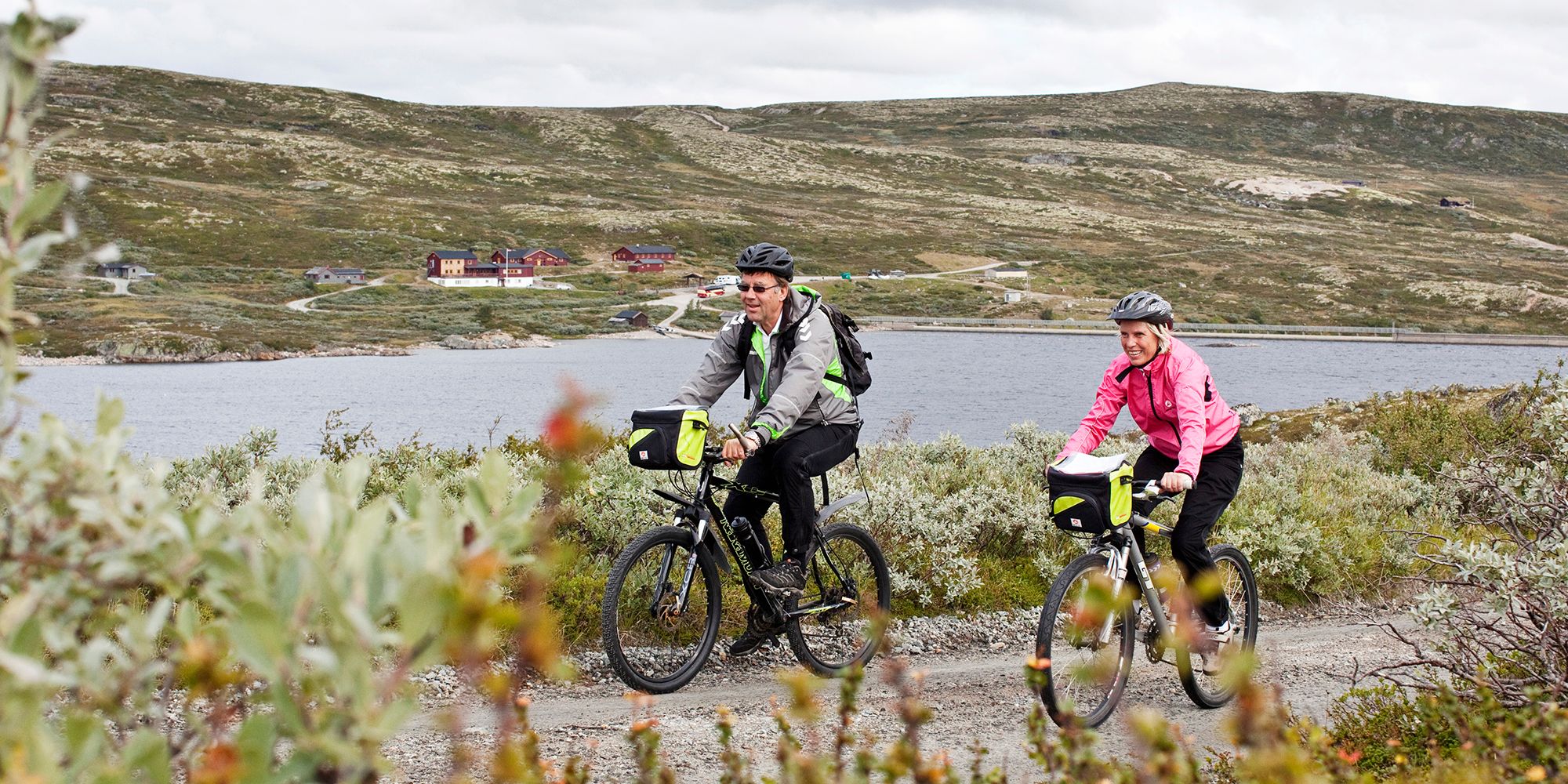 A couple is biking at the Hardangervidda mountain plateau in Eastern Norway