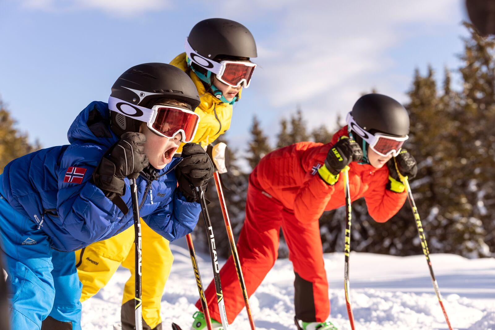Three alpine skiing kids ready for action in the slopes of Hafjell