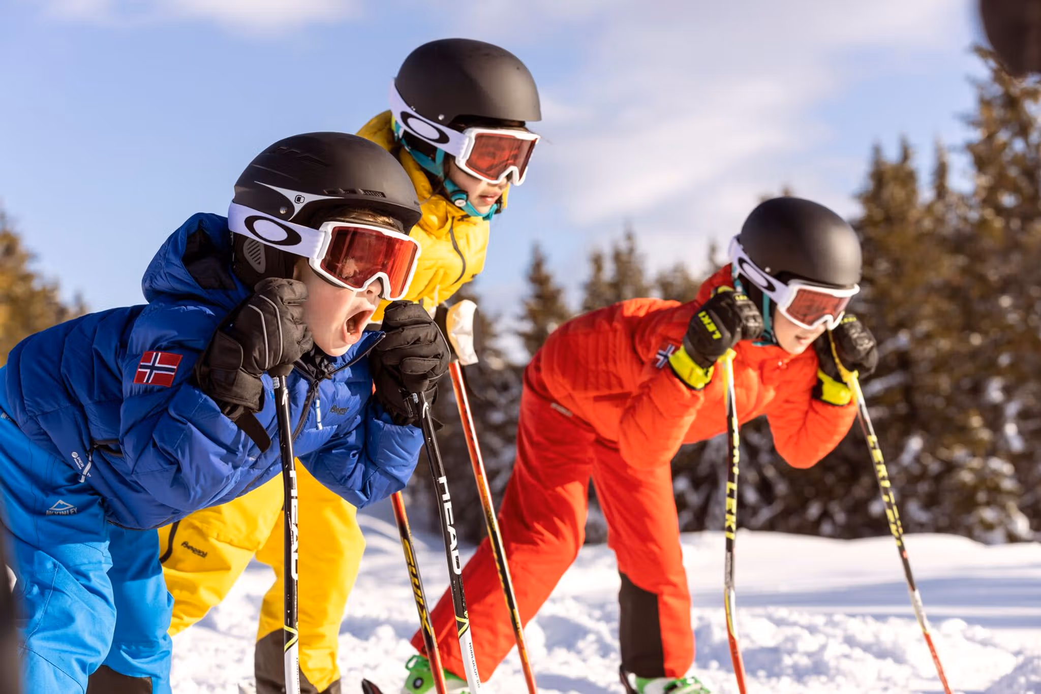 Three alpine skiing kids ready for action in the slopes of Hafjell