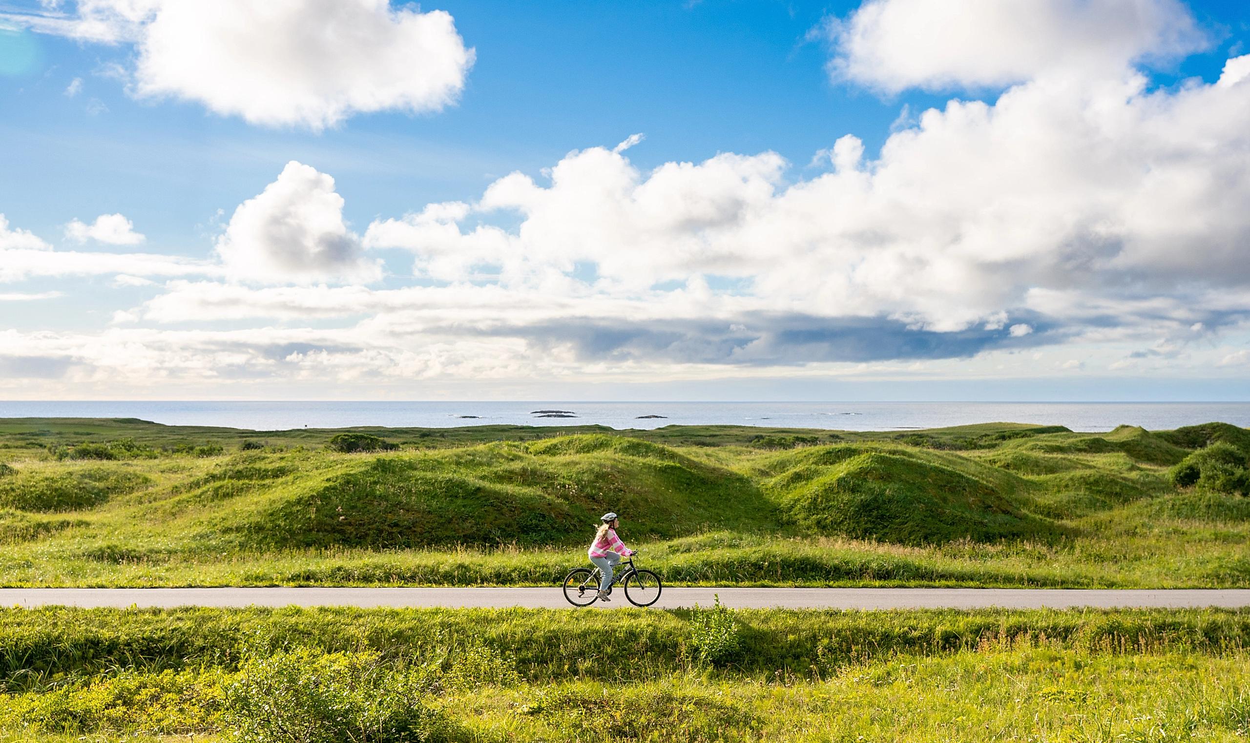 Woman biking the Norwegian Scenic Route at Andøya
