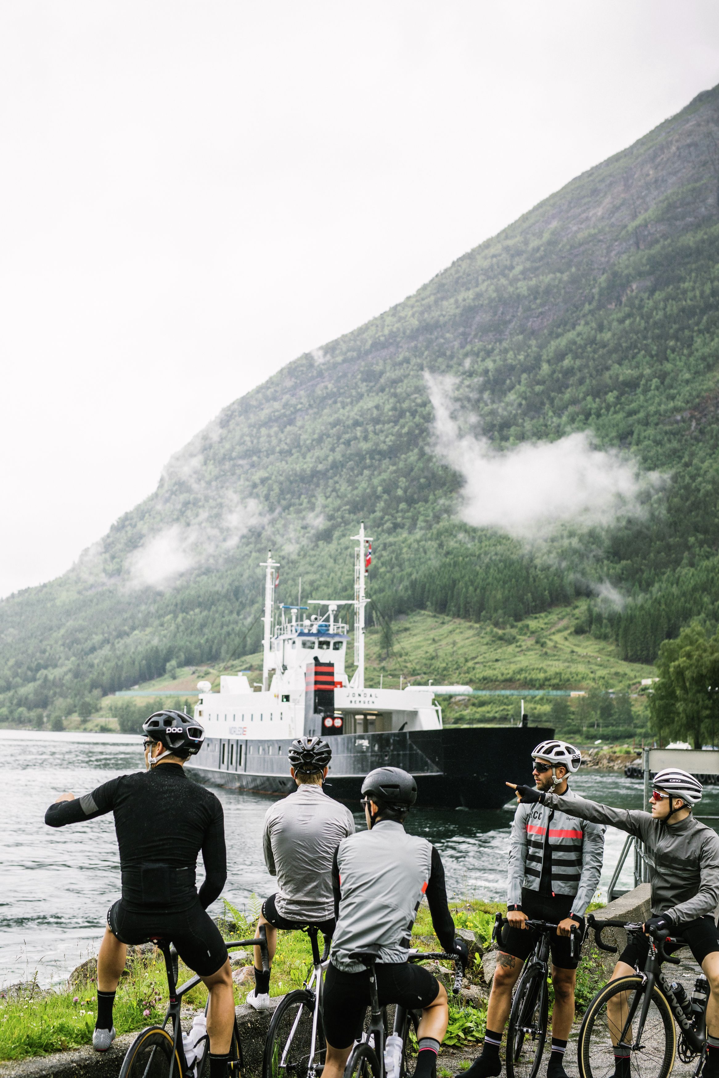 A group of road cyclists waiting for a ferry in Fjord Norway