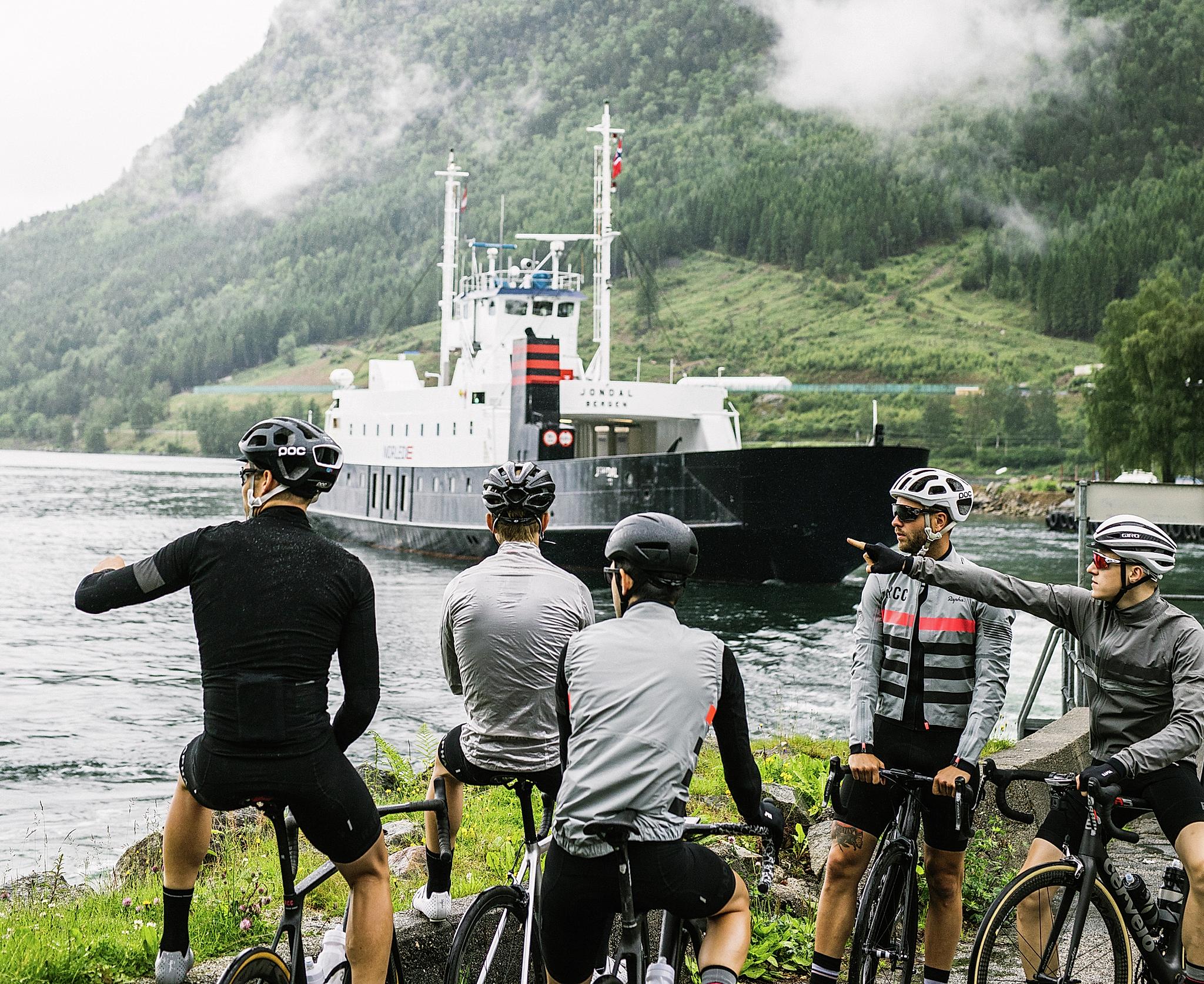 A group of road cyclists waiting for a ferry in Fjord Norway