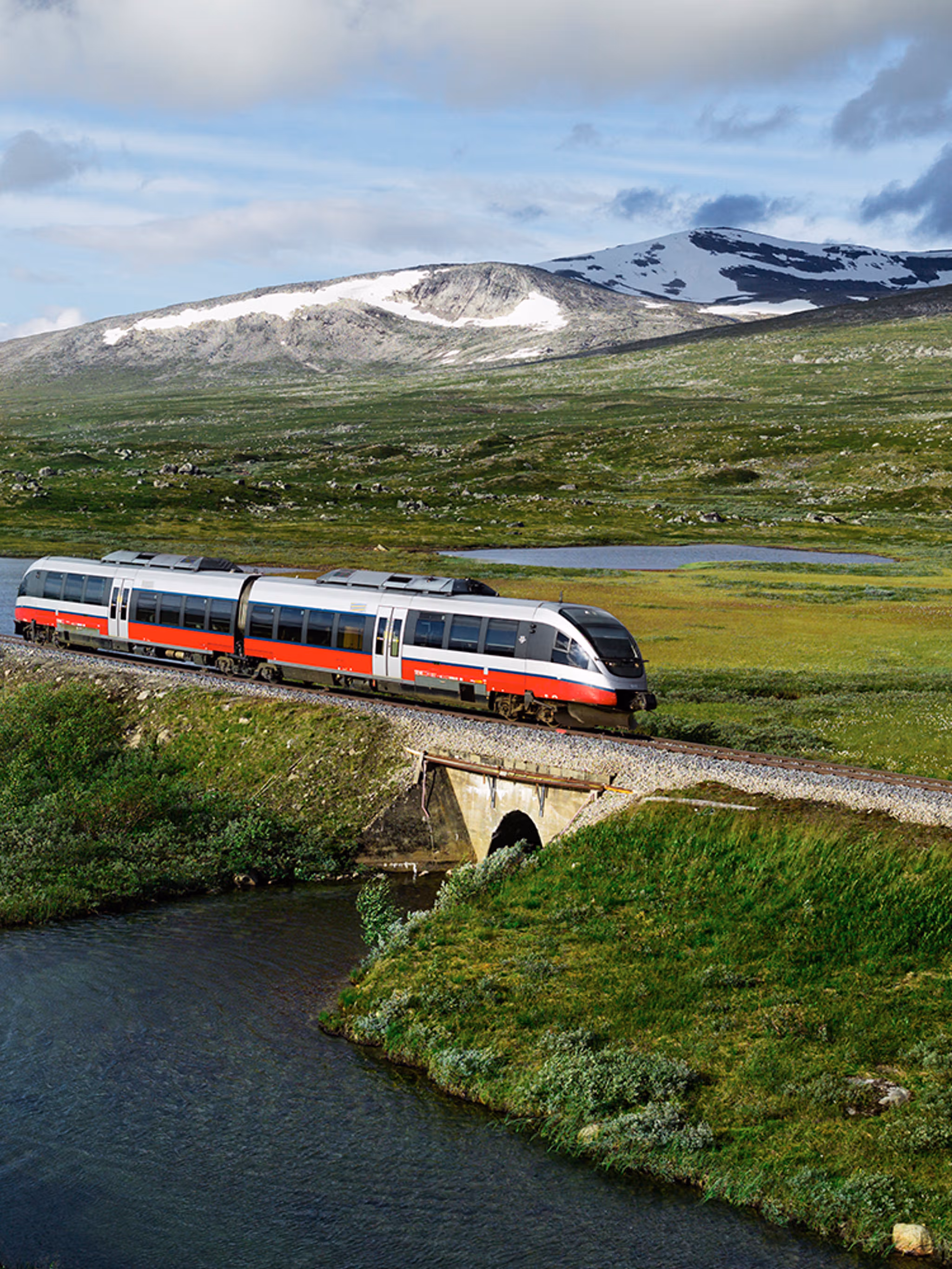 A train passing by a lake in Saltfjellet mountain area in Nordland