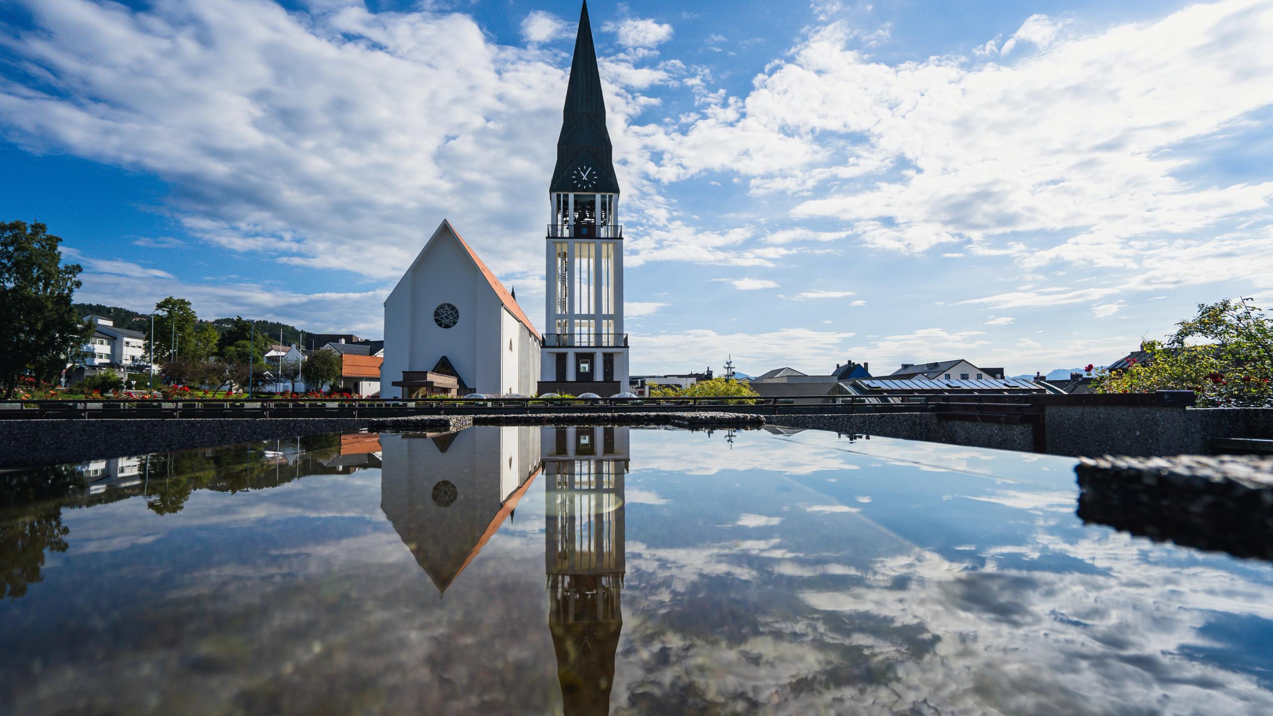 Molde Cathedral with a small reflecting pool in front.