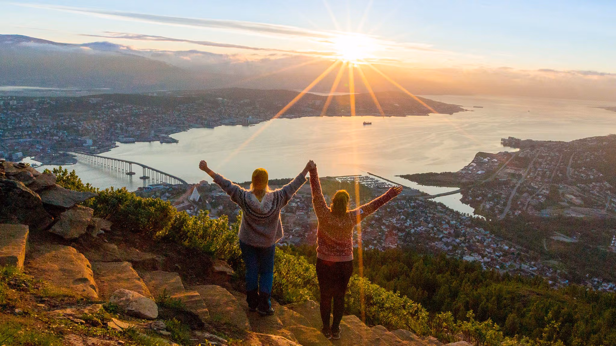 Two women are hiking up the Sherpa staircase to Mount Storsteinen in Tromsø, Northern Norway