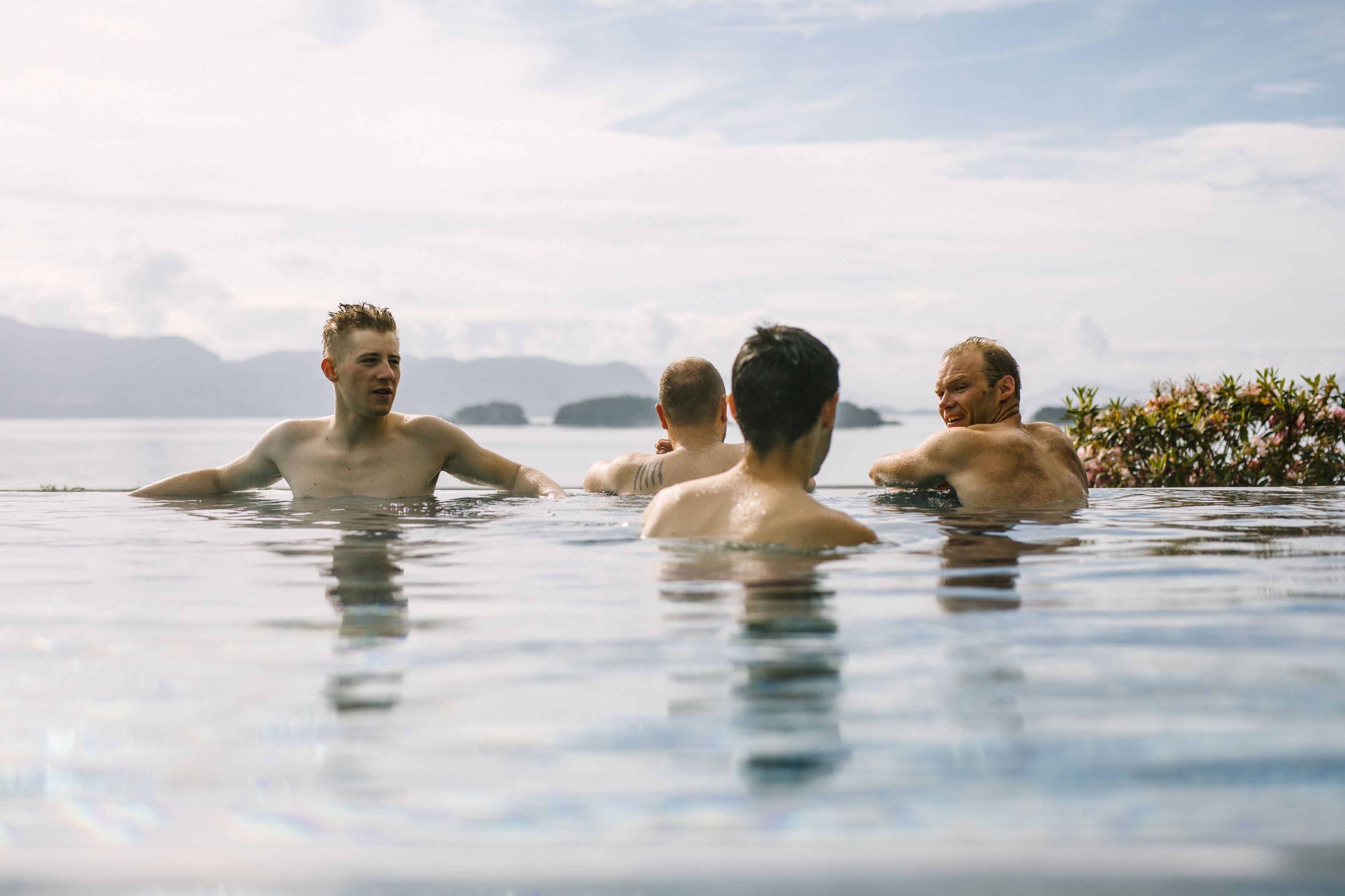 Four men in an outdoor pool in Fjord Norway