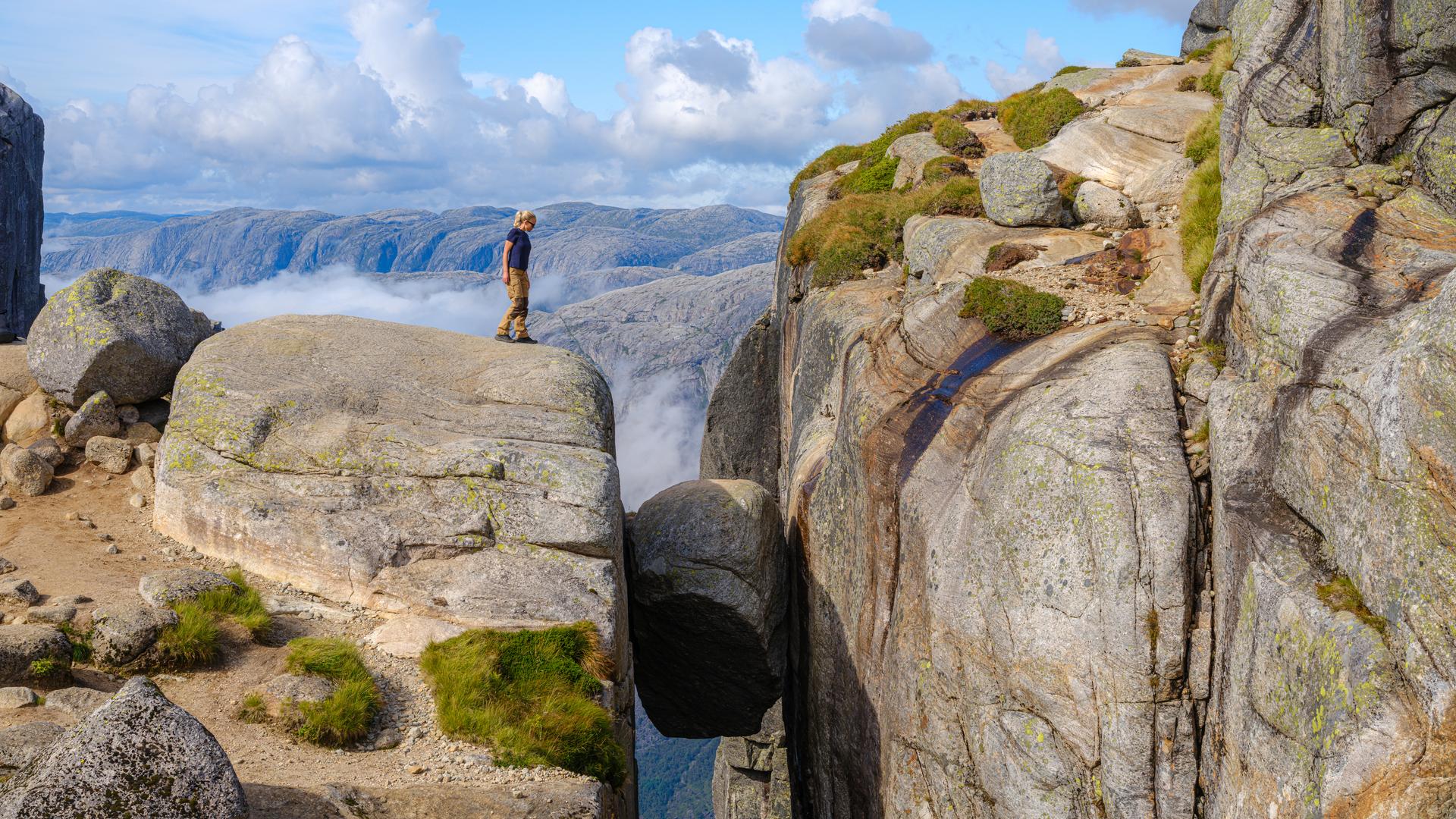 A boulder lodged in a cliff.