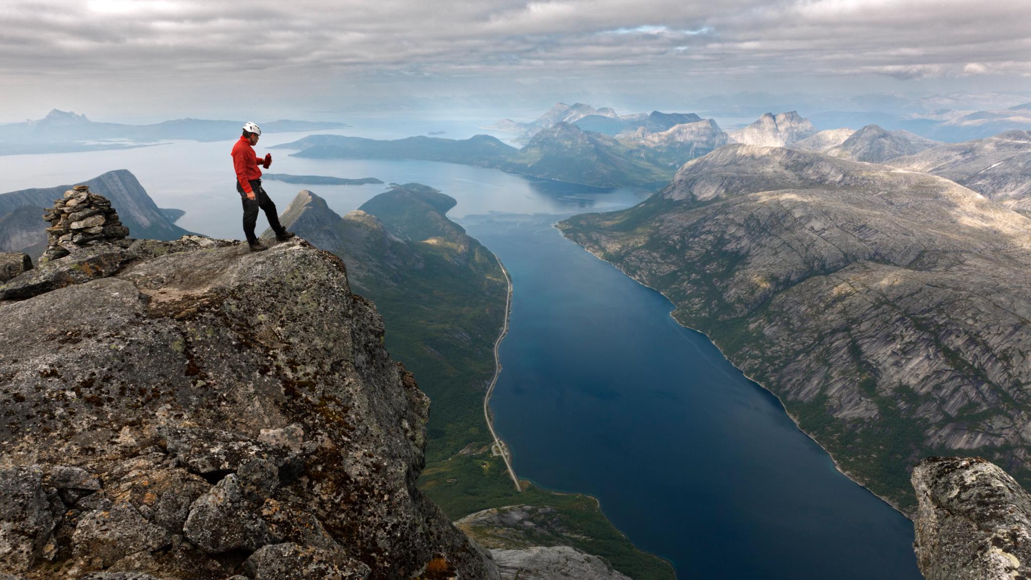 A person is admiring the view from the top of Mount Stetinden outside of Narvik in Northern Norway