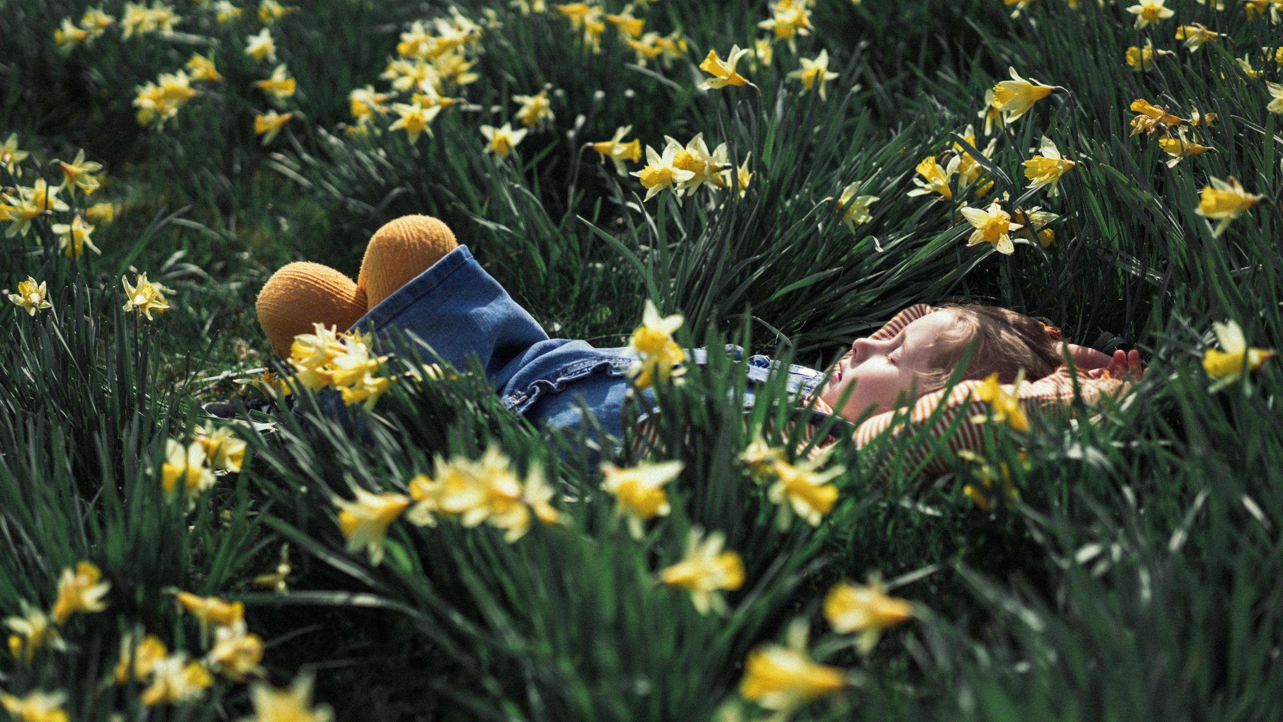 Girl relaxing in a field of flowers, Fjord Norway.
