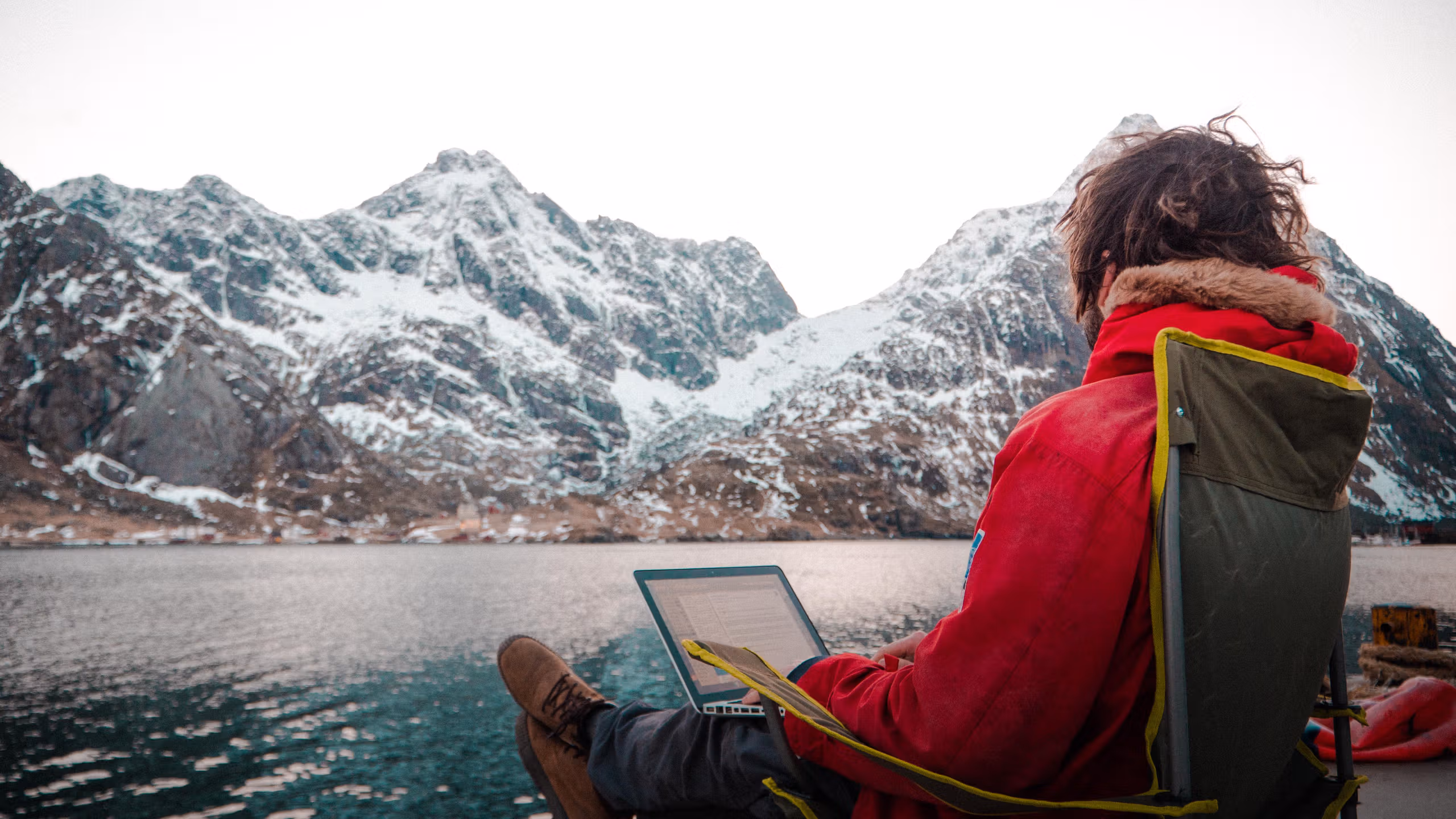 En mann jobber utendørs på Arctic Coworking Lodge i Lofoten, Nord-Norge