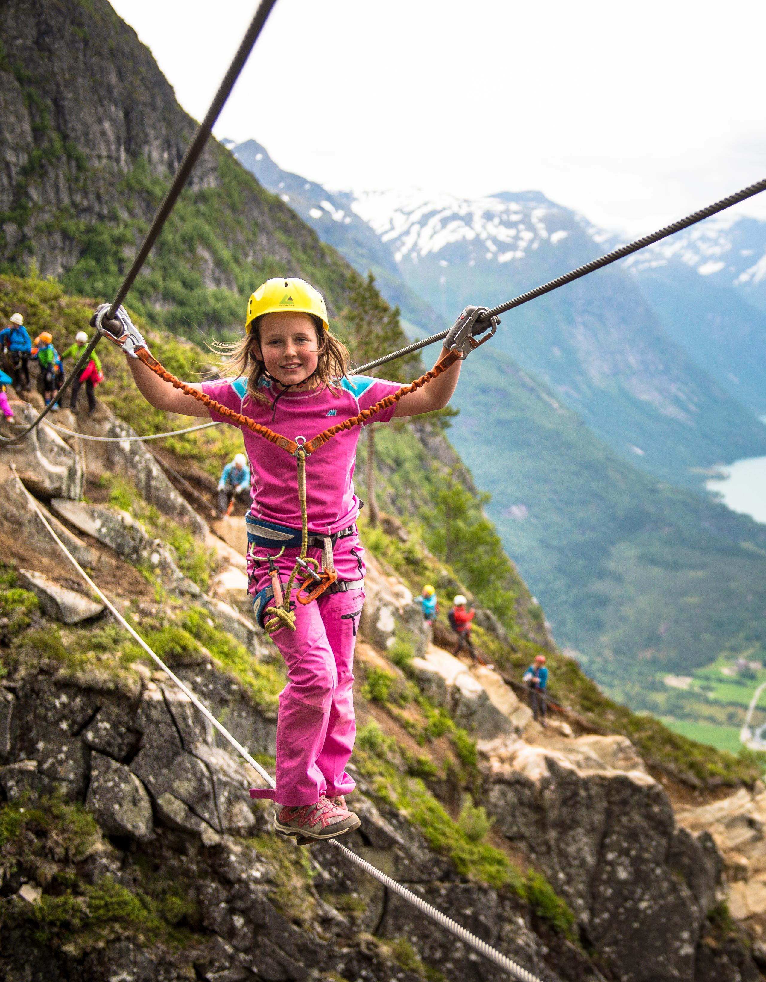 Young girl crossing the Via Ferrata in Loen in Fjord Norway