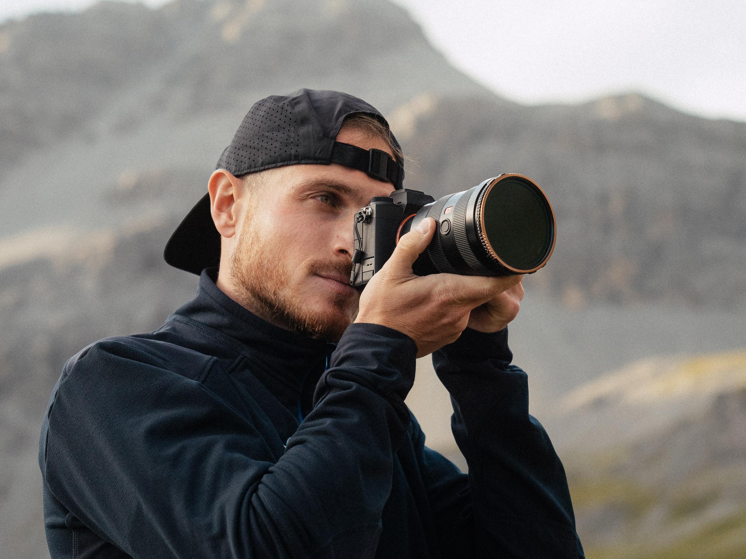 A photographer holding a camera.