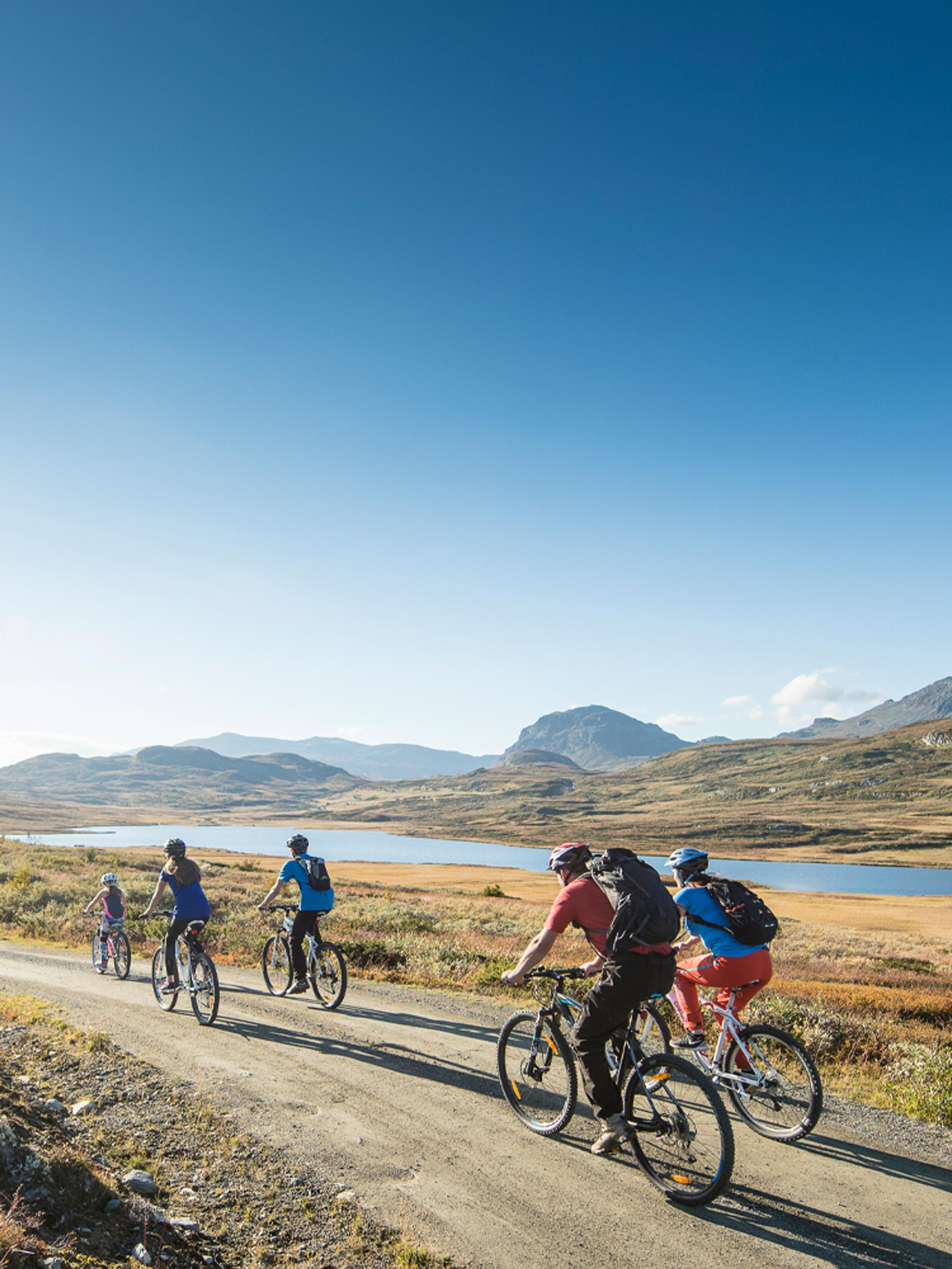 People biking on a gravel road in Ål in Hemsedal, Eastern Norway