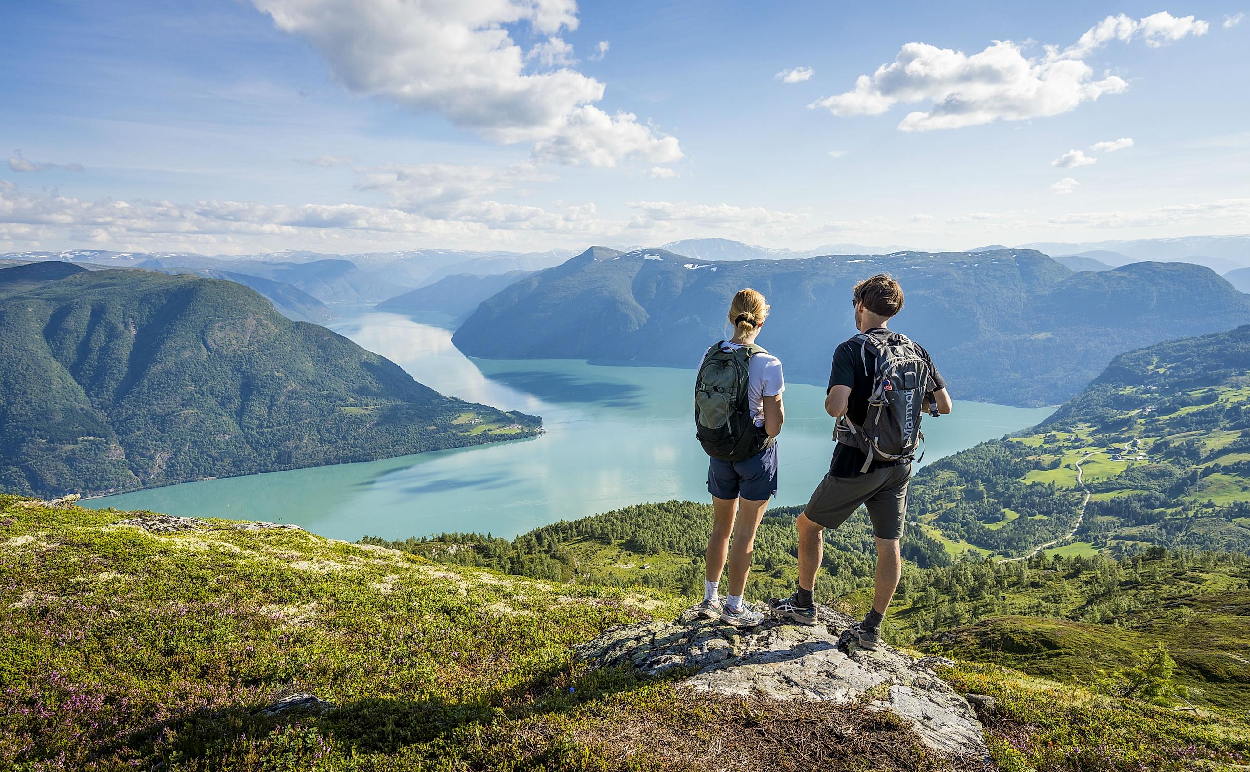Two people admiring the view from the top of mount Molden in the Sognefjord area of Fjord Norway