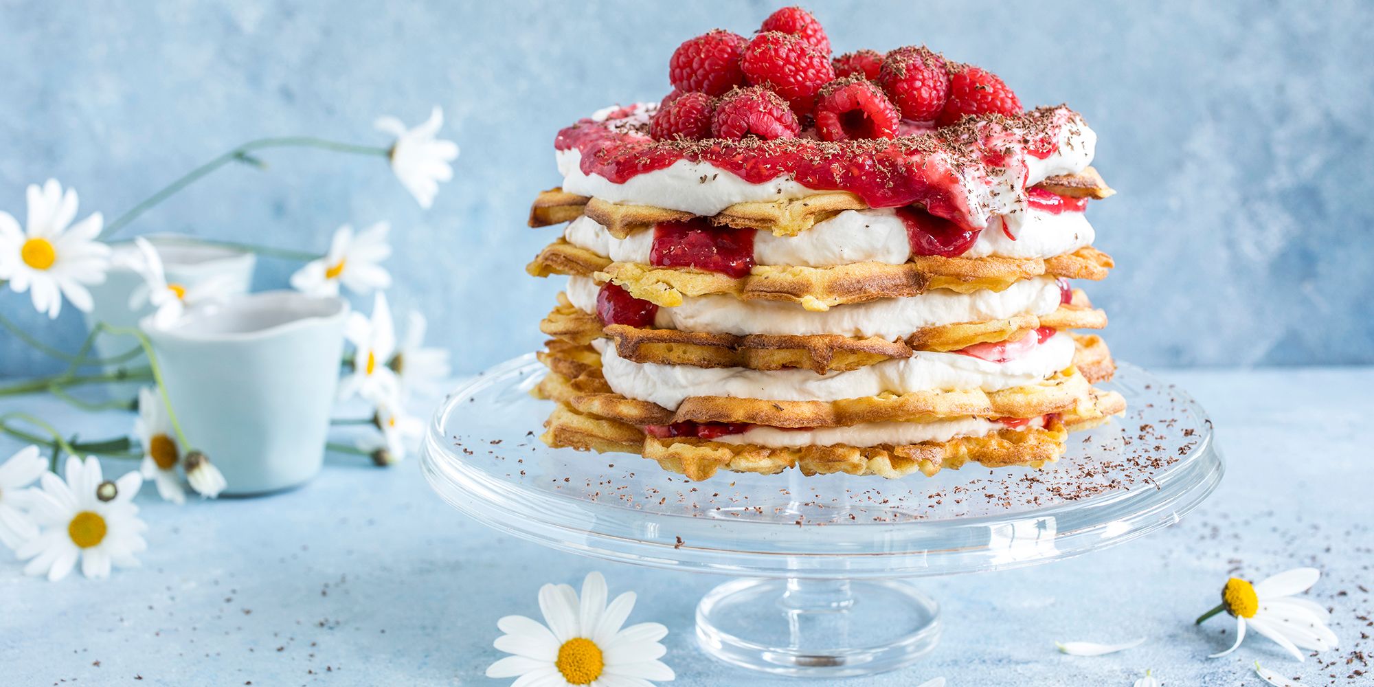 A waffle cake with vanilla custard and raspberries