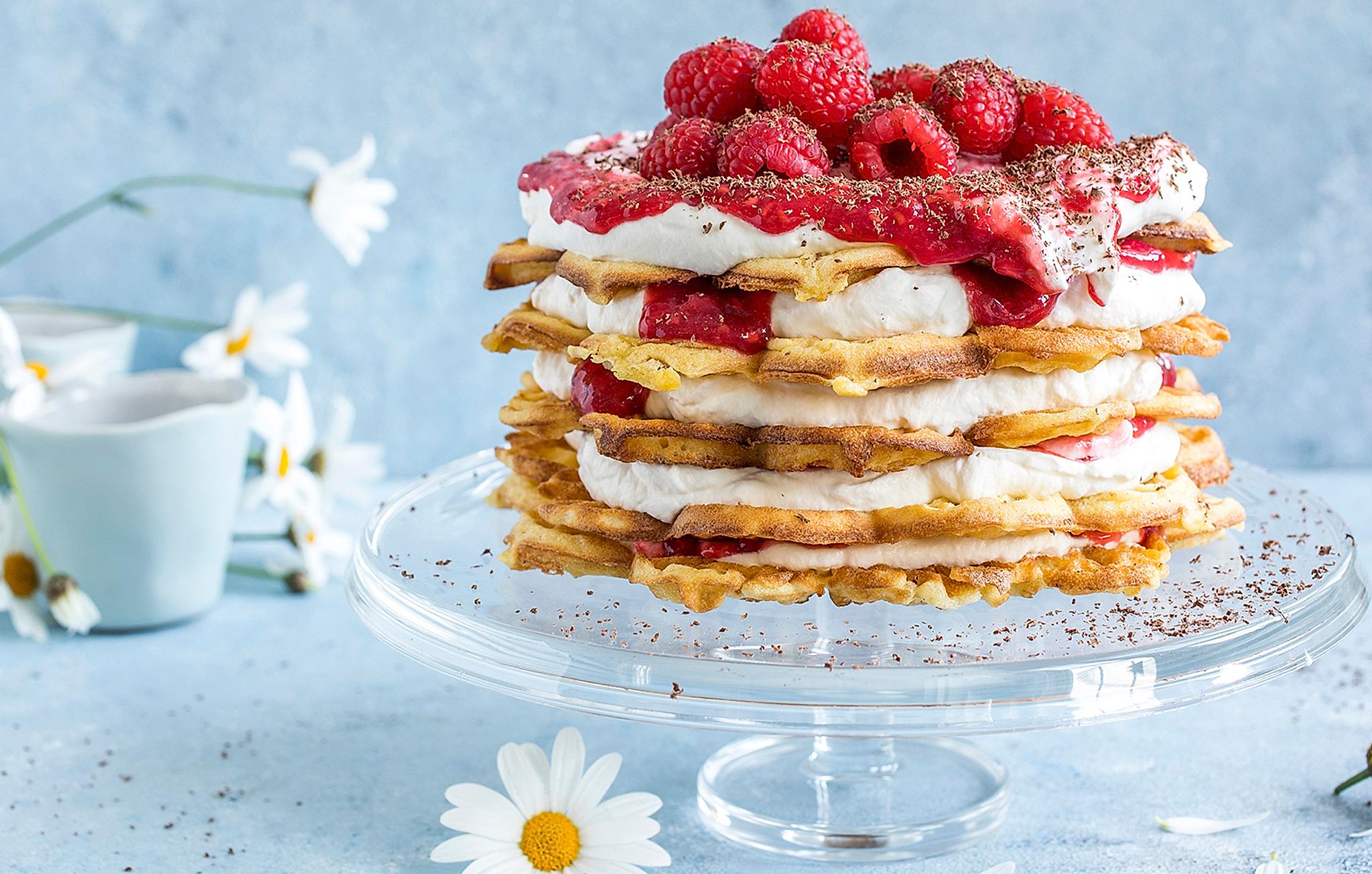 A waffle cake with vanilla custard and raspberries