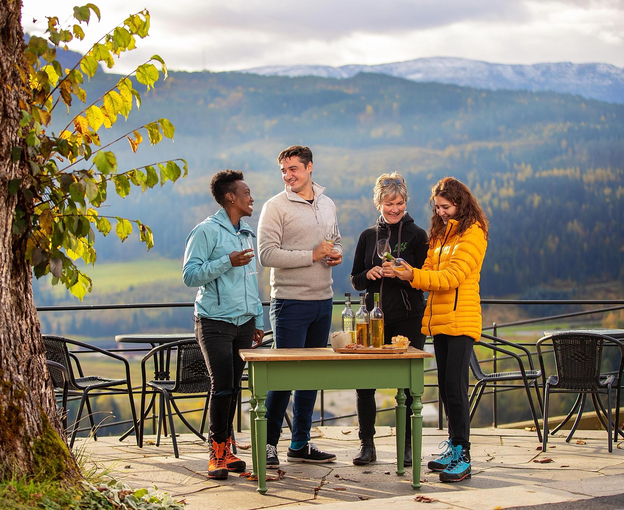 A group of people tasting ciders at Syse gard in Hardanger, Fjord Norway