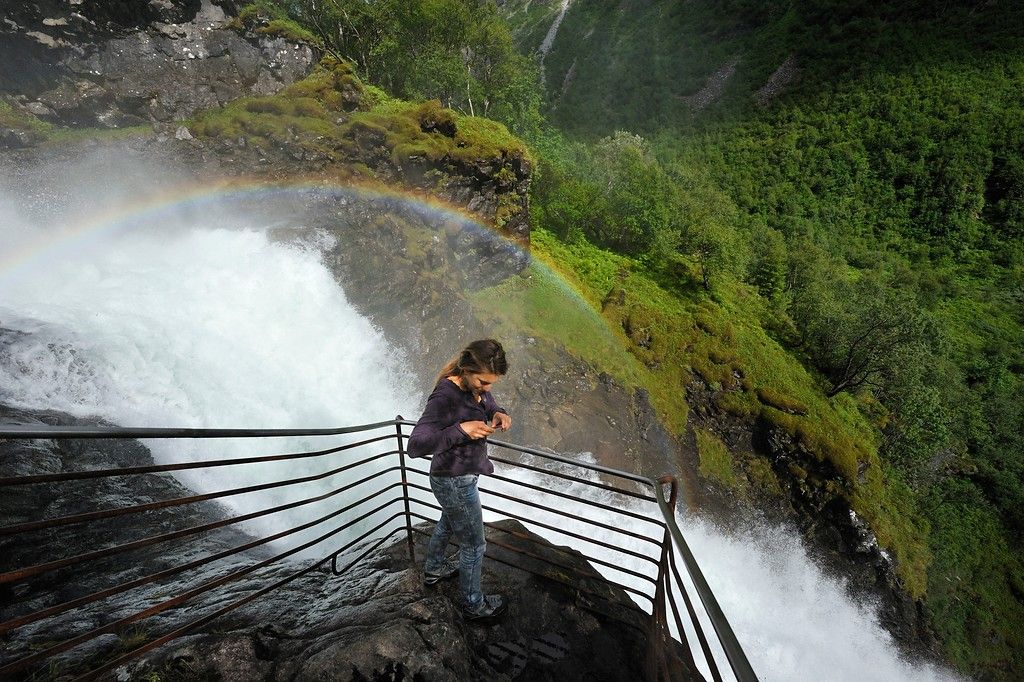 A woman looking at a waterfall.