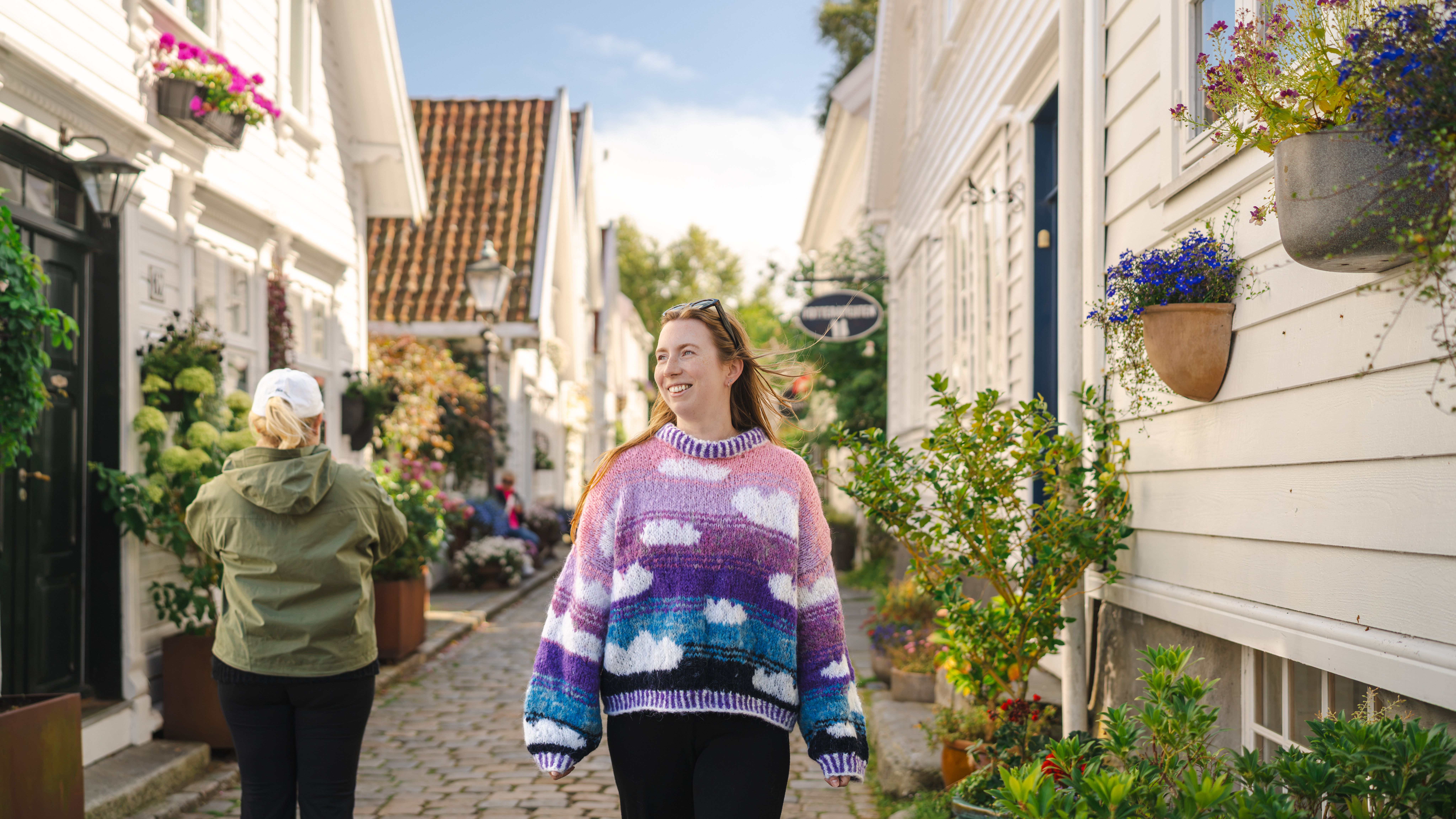 A woman wandering through the old town in Stavanger.