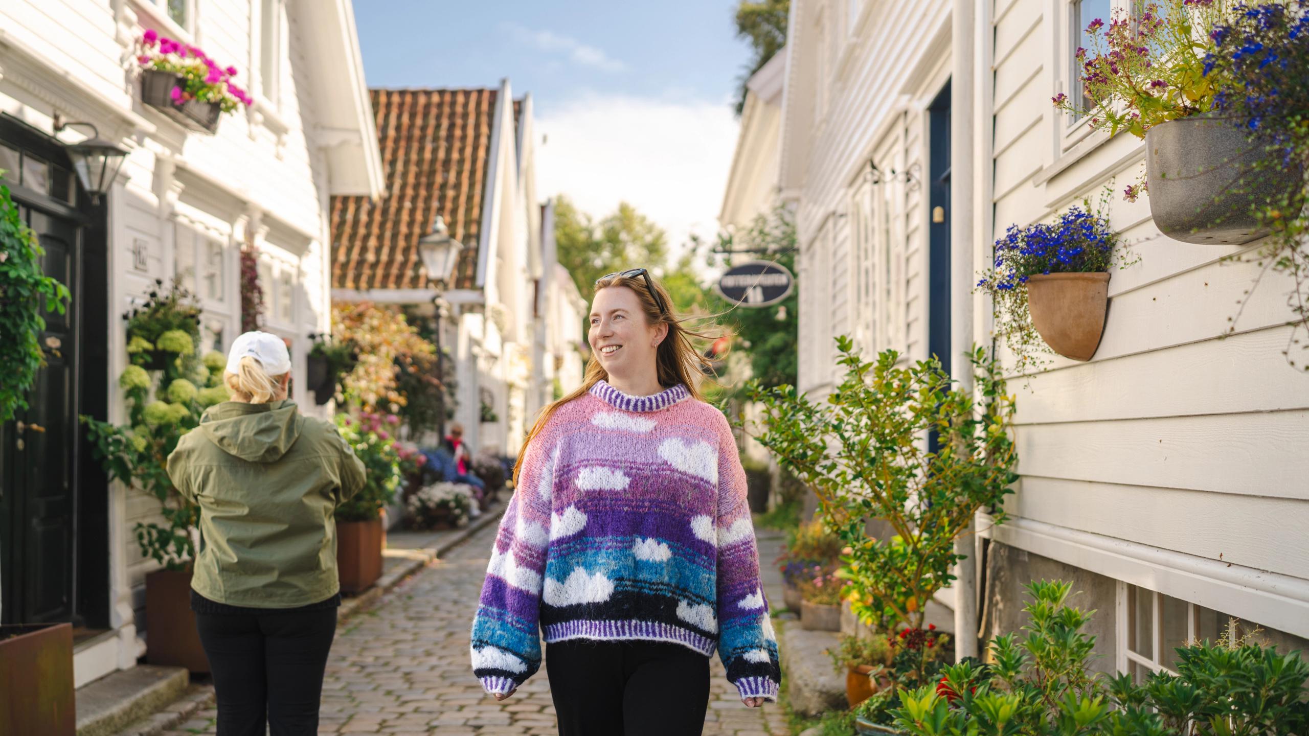 A woman wandering through the old town in Stavanger.