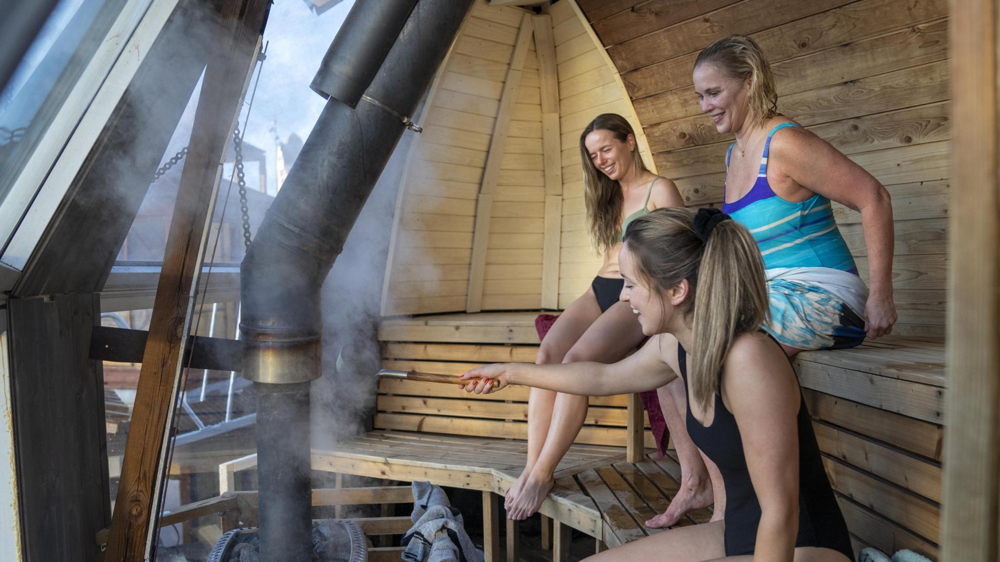 Friends sitting in Sauna at Oslo Badstuforening in Oslo, Eastern Norway