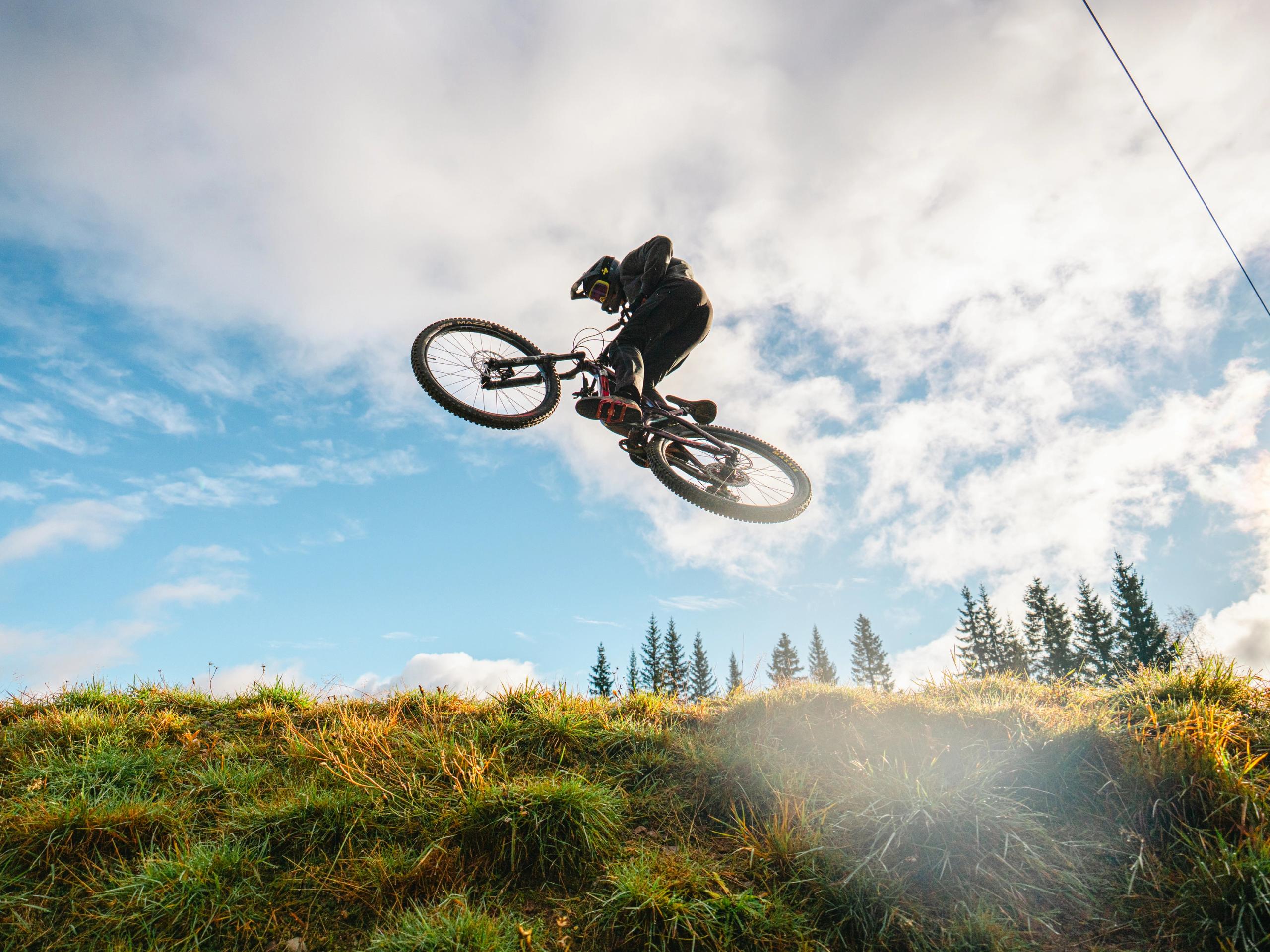 A boy on a bike in mid-air.