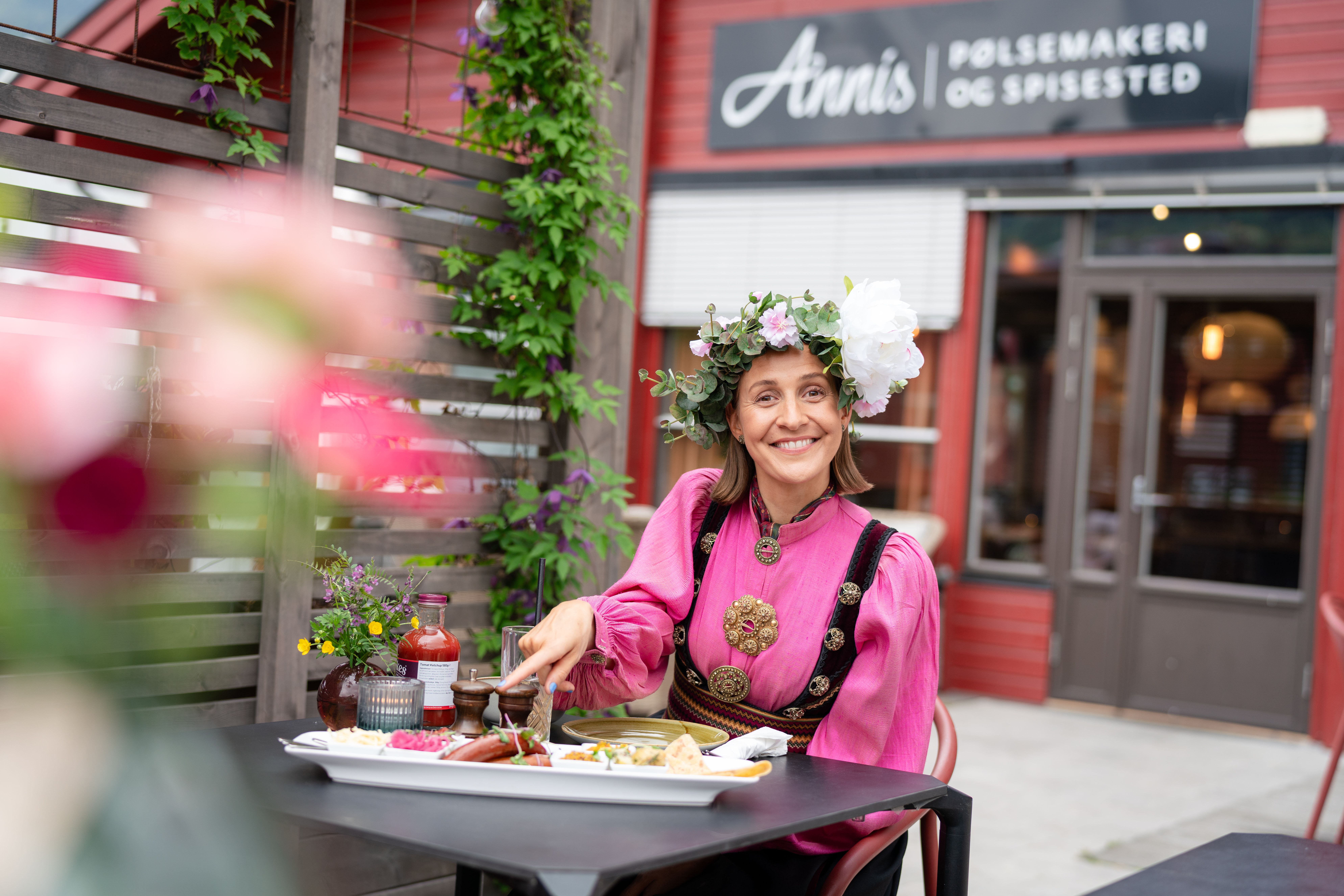 Woman eating at Annis Pølsemakeri (sausage factory) in Ringebu