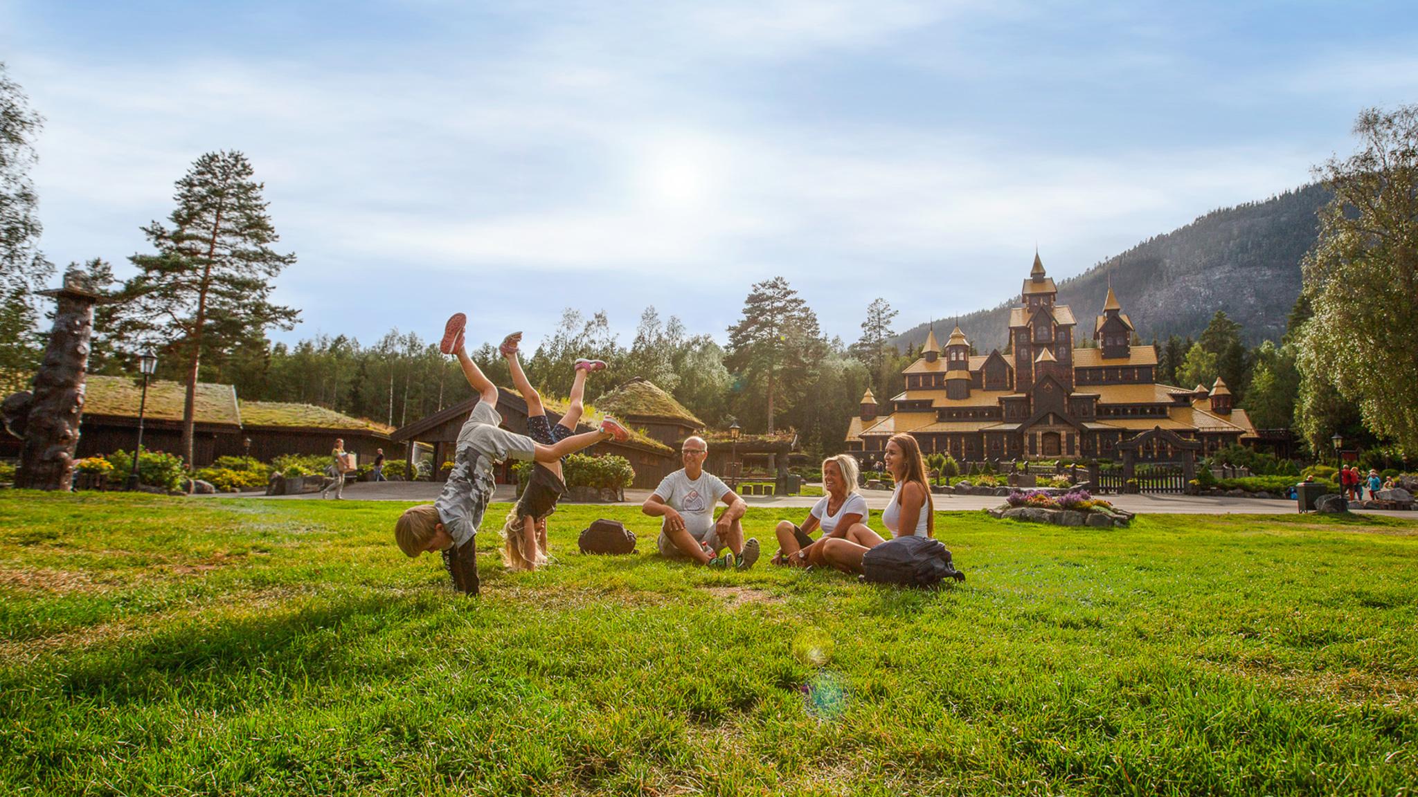 A family is having fun in front of the Fairy Tale Castle in Hunderfossen Adventure Park in Lillehammer, Eastern Norway