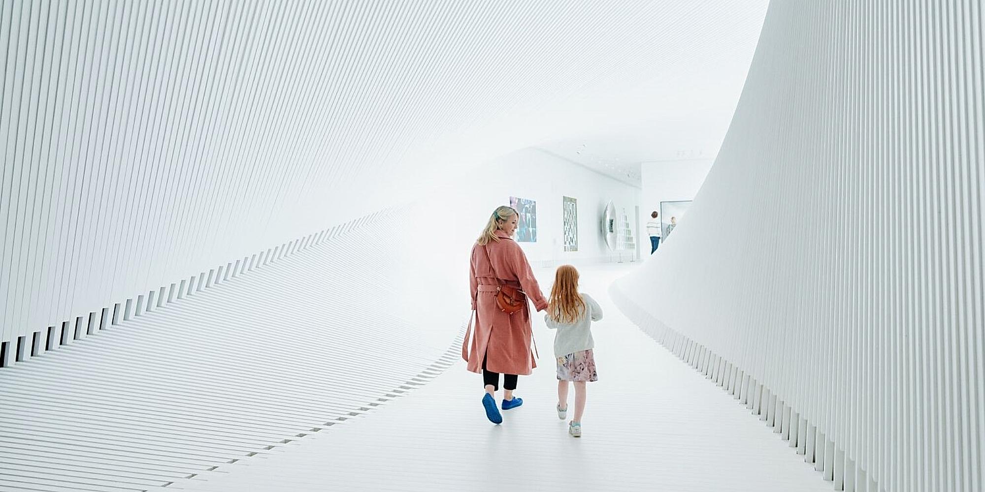 Mother and child walking inside The Twist at Kistefos, Hadeland