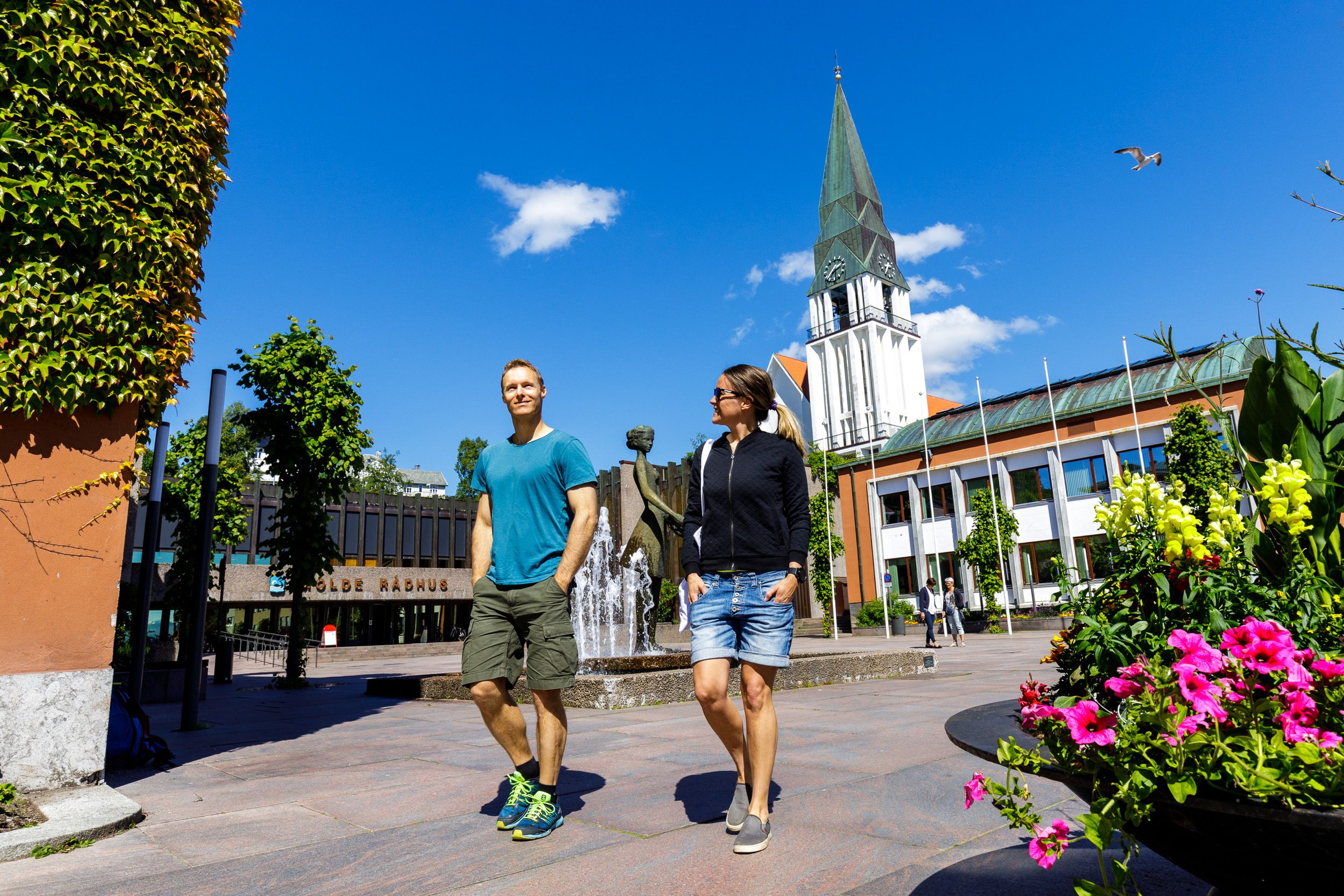 Two people in front of the the Molde Cathedral in Northwest, Fjord Norway.