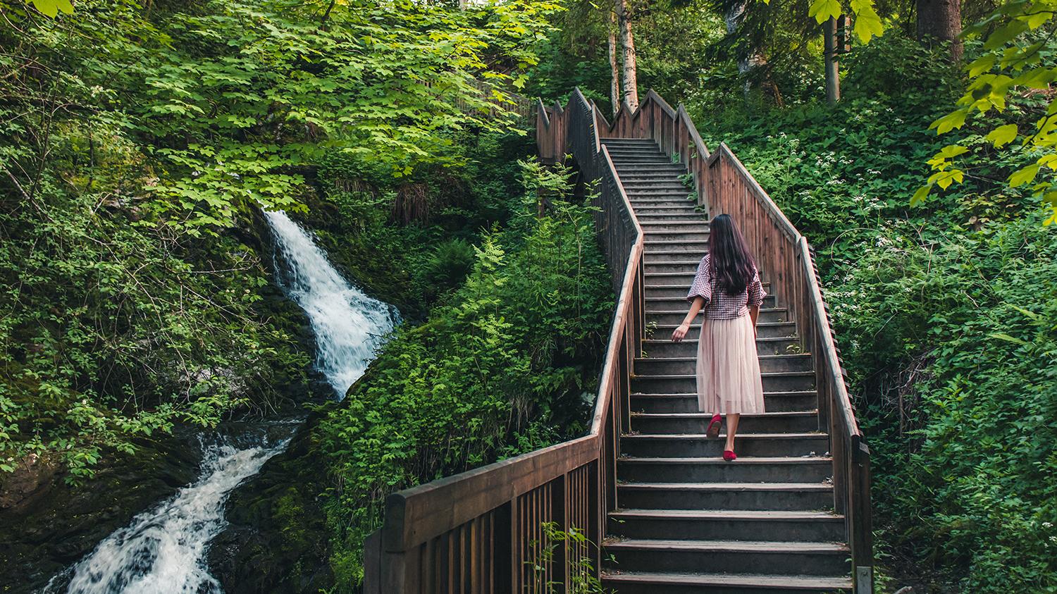Woman walking stairs of the Iladalen trail, Trondheim, Norway