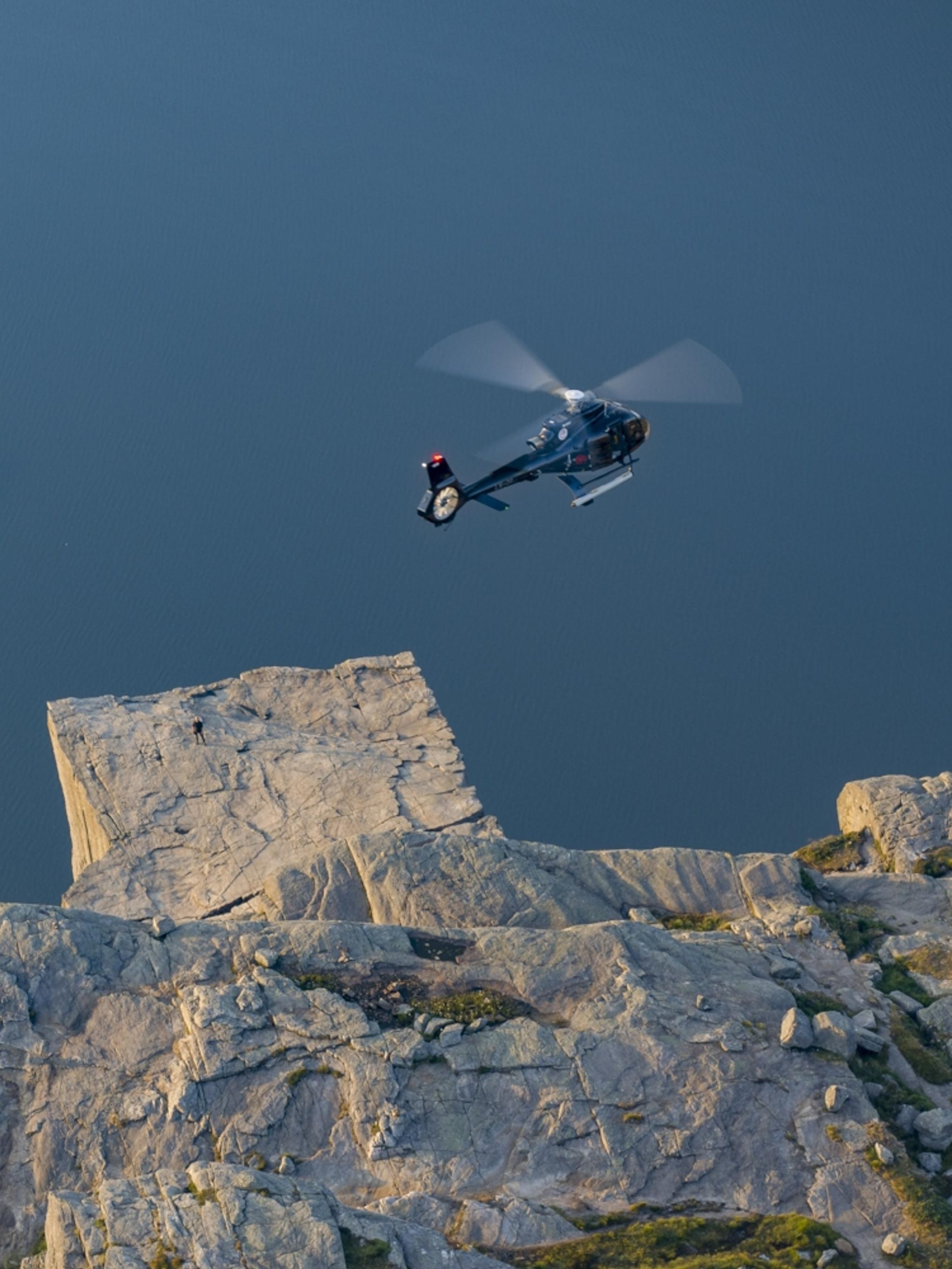 Helicopter flying over Preikestolen (The Pulpit Rock) in Fjord Norway