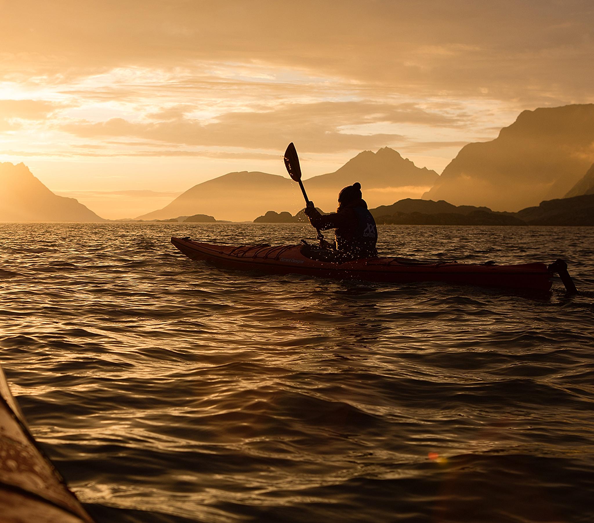 Kayaking under the midnight sun in Lofoten, Northern Norway