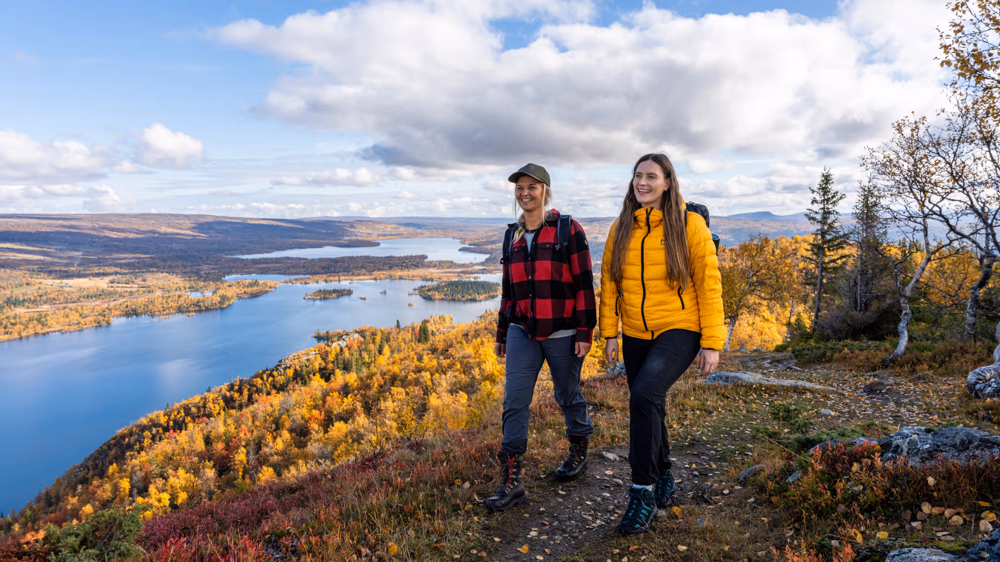 Two women are hiking to the top of a mountain in Hemsedal, Eastern Norway