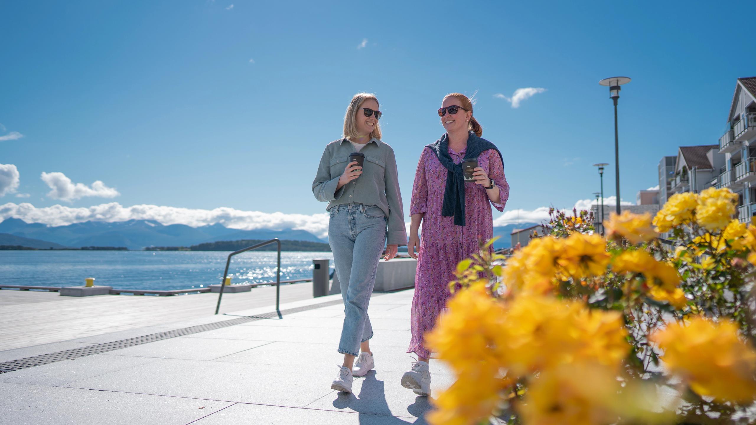Two women walking down The Seafront promenade in Molde
