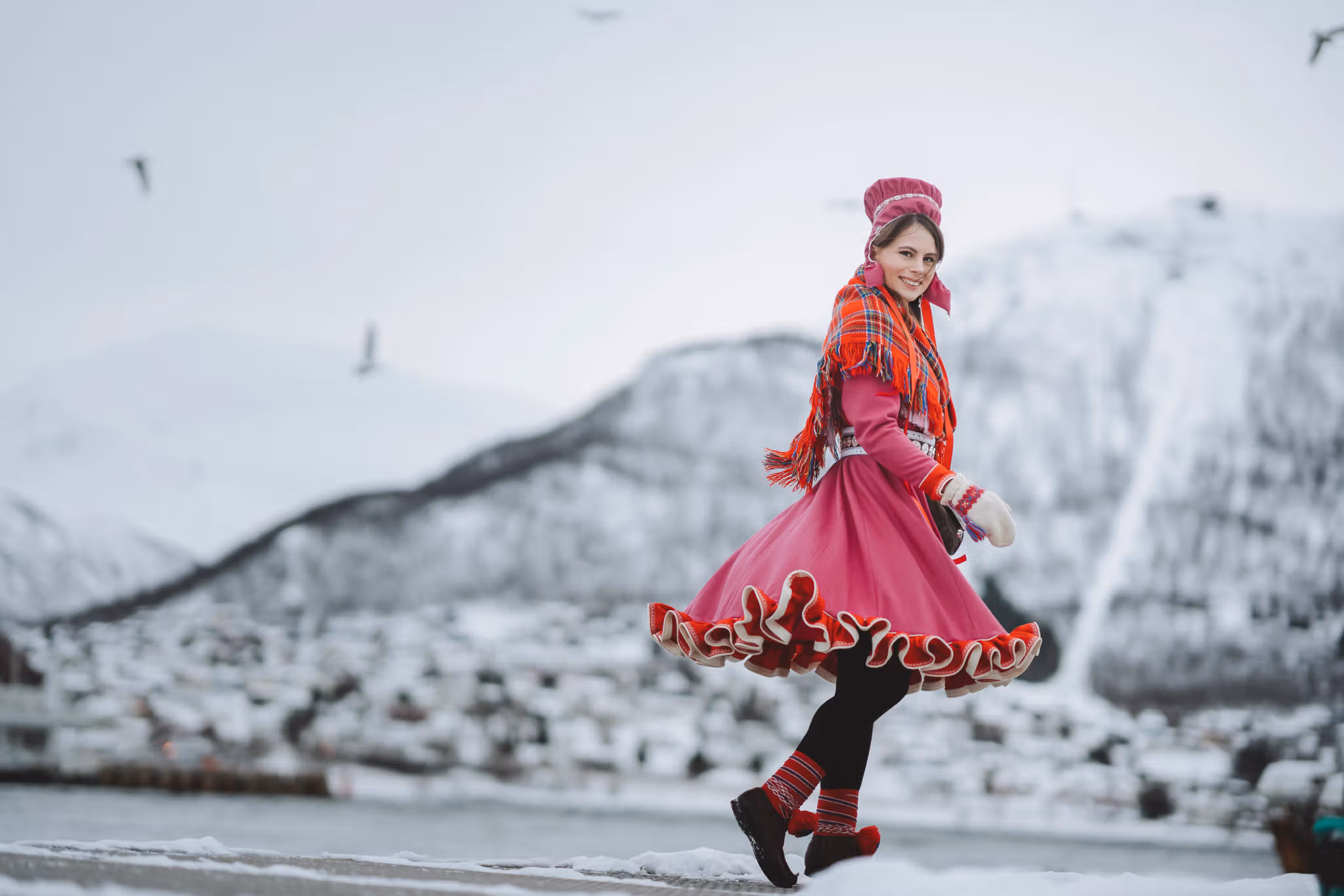 A woman is wearing traditional sami clothing in Tromsø, Northern Norway