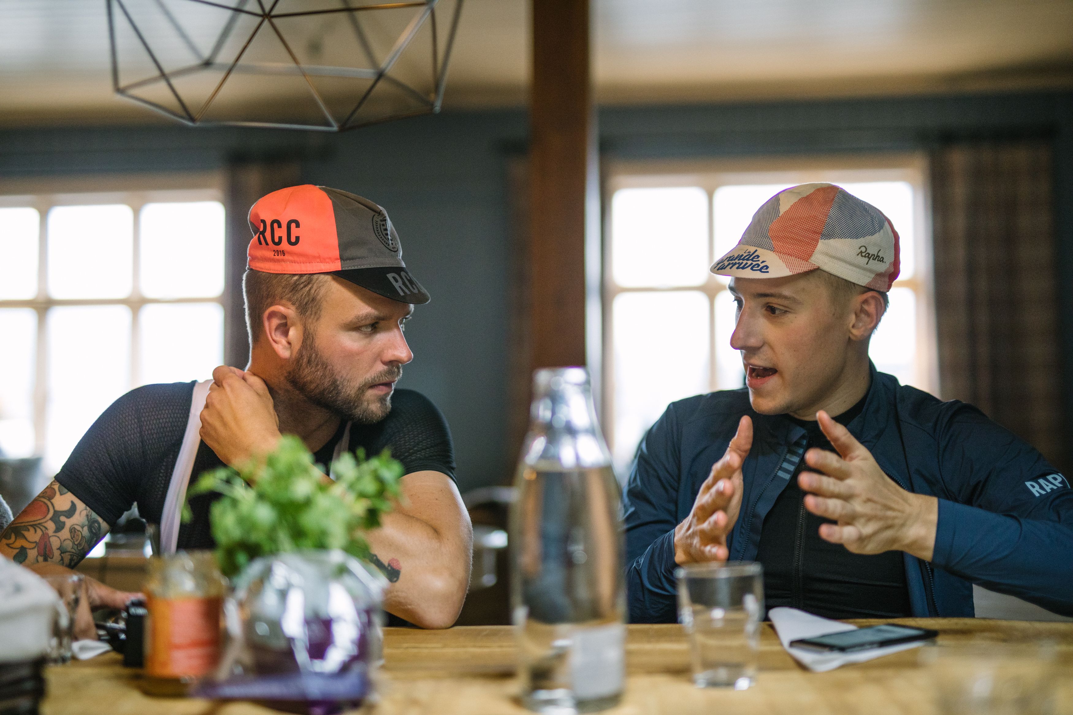 Two road cyclists on a break in a restaurant in Fjord Norway