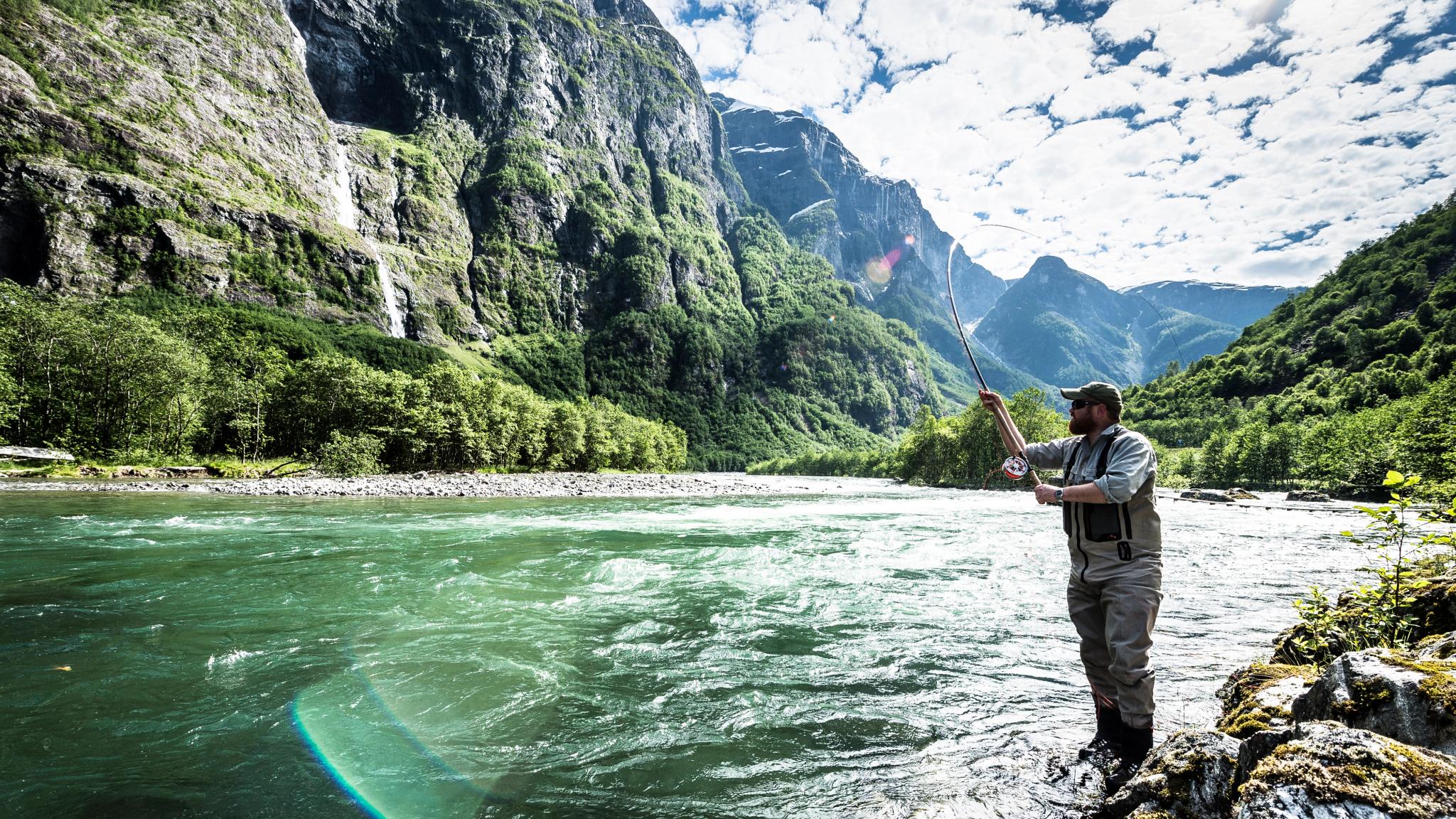 A man fishing for wild salmon in the Nærøydalselva in Fjord Norway