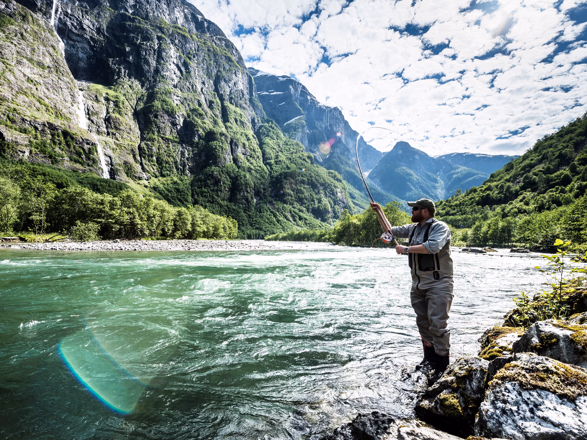 A man fishing for wild salmon in the Nærøydalselva in Fjord Norway