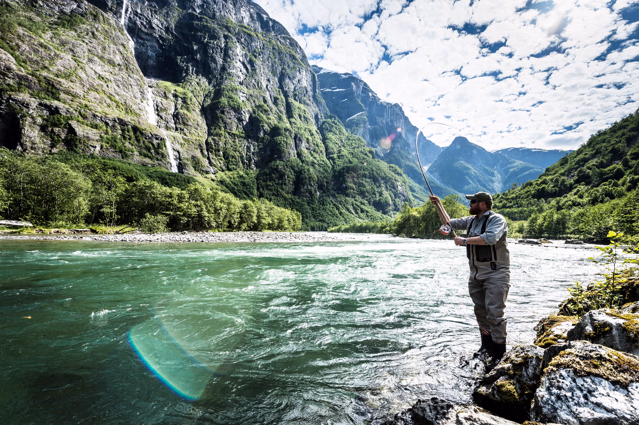 A man fishing for wild salmon in the Nærøydalselva in Fjord Norway