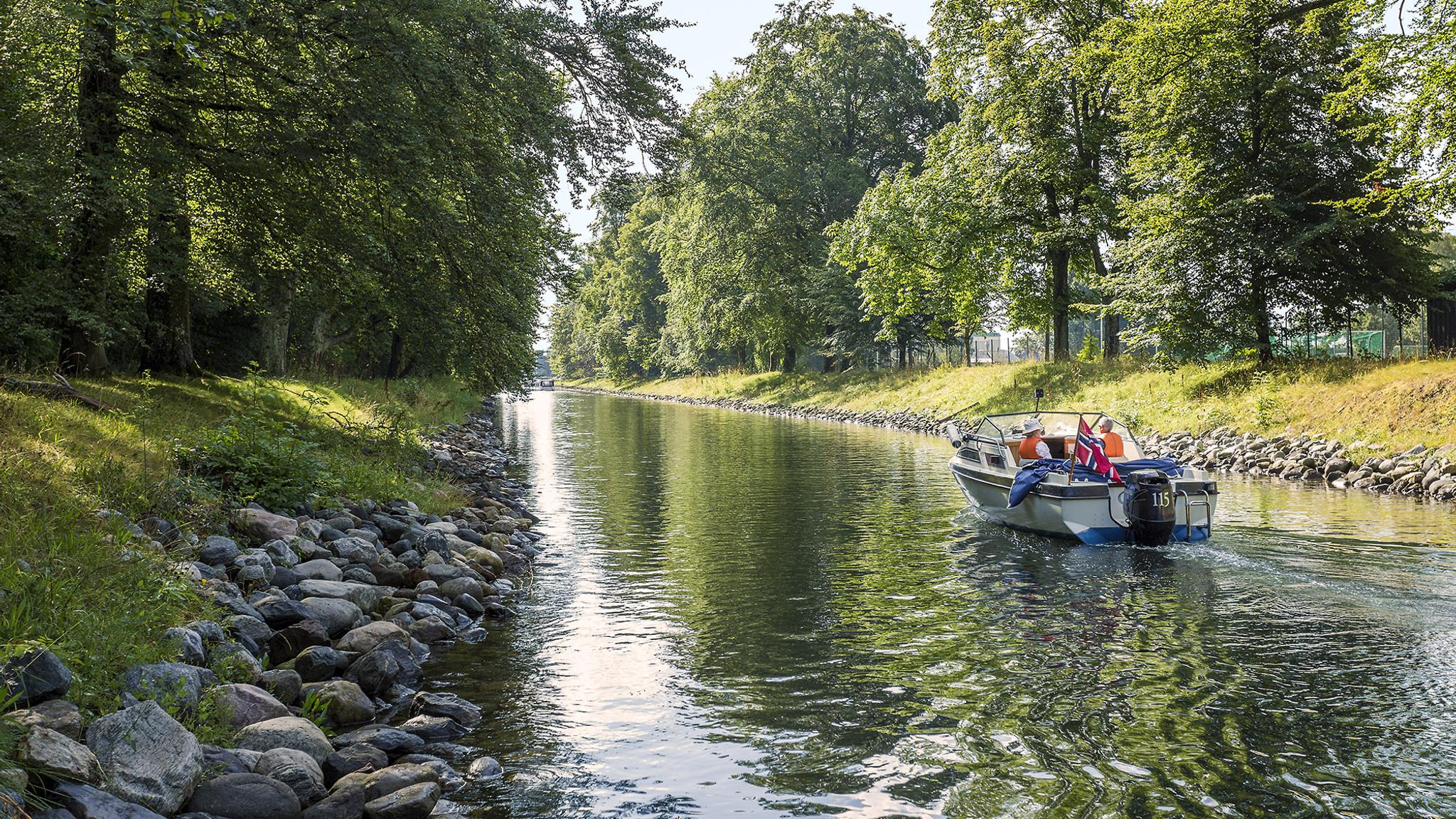 A boat drives in a leisurely pace in the Hortenkanalen canal in Horten in Vestfold, Eastern Norway