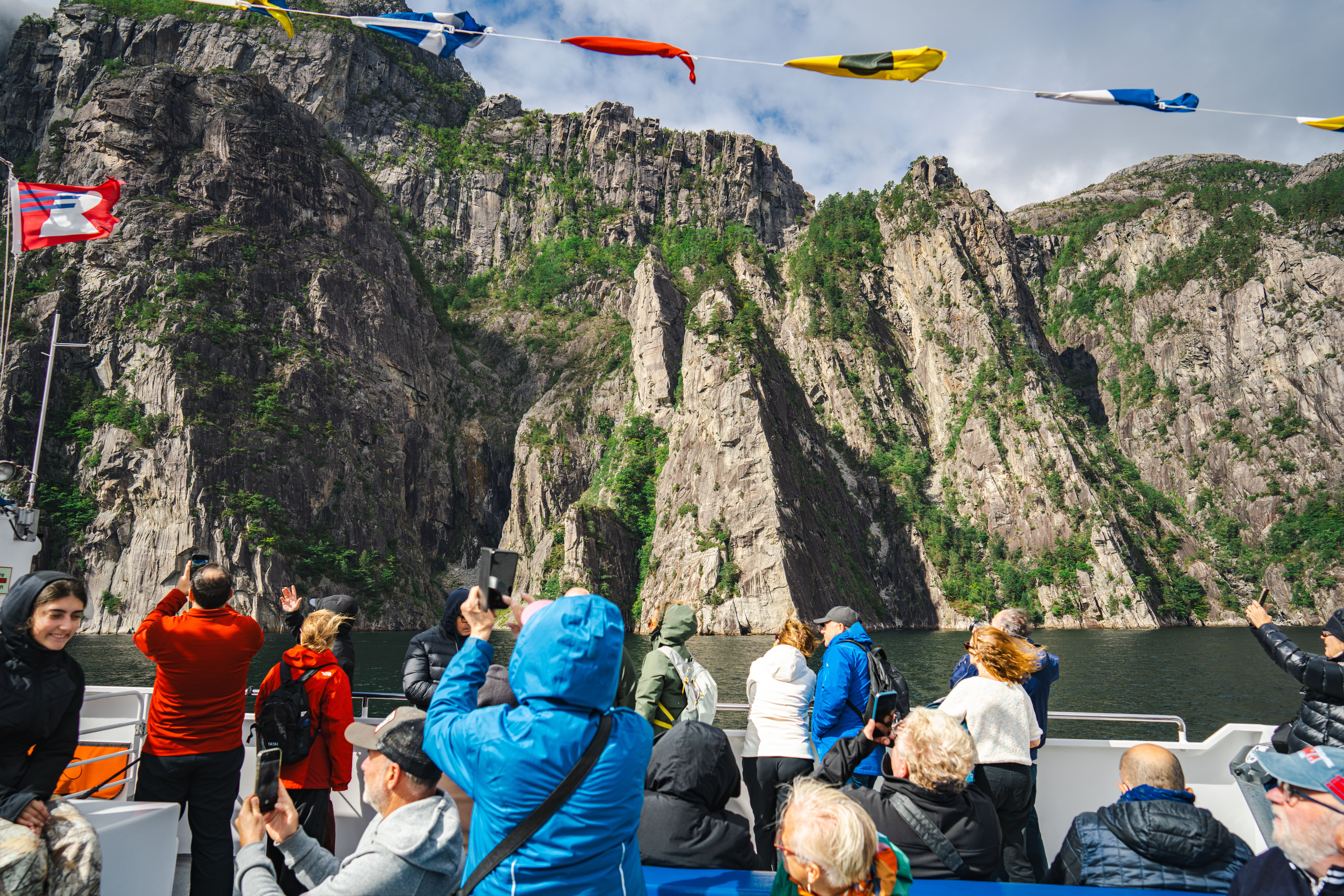 Tourists taking pictures on a cruise in the Lysefjord.